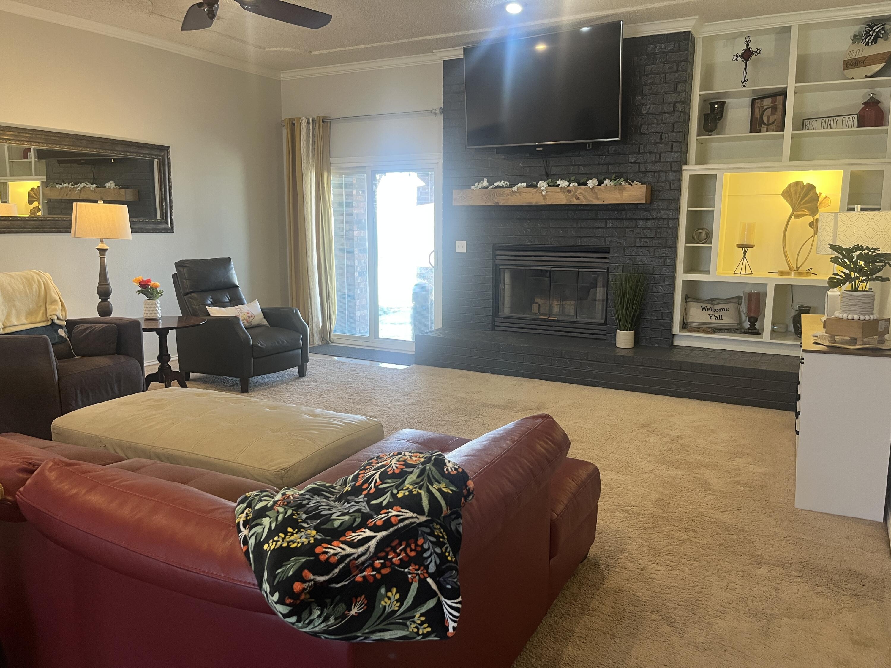 2222 South 2nd Place Lamesa, TX 79331 - Photo 4 of 44 a living room with furniture and a fireplace