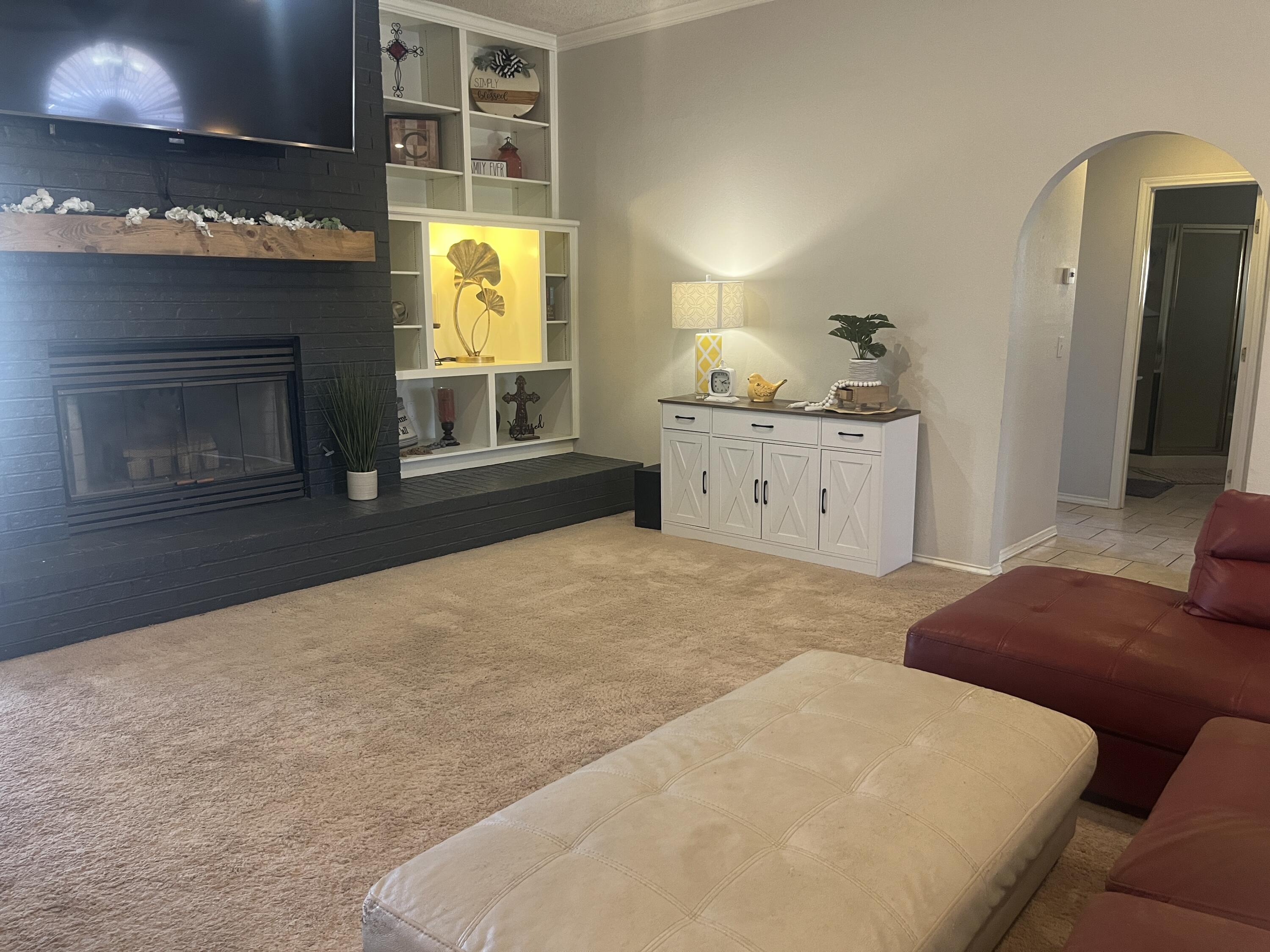 2222 South 2nd Place Lamesa, TX 79331 - Photo 6 of 44 a bedroom with a bed and a fireplace