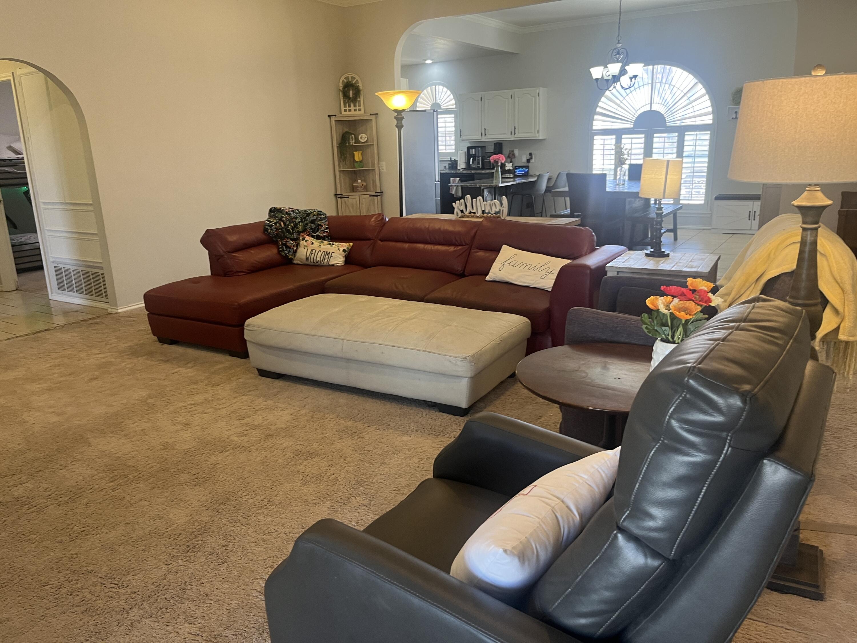 2222 South 2nd Place Lamesa, TX 79331 - Photo 7 of 44 a living room with furniture and a chandelier