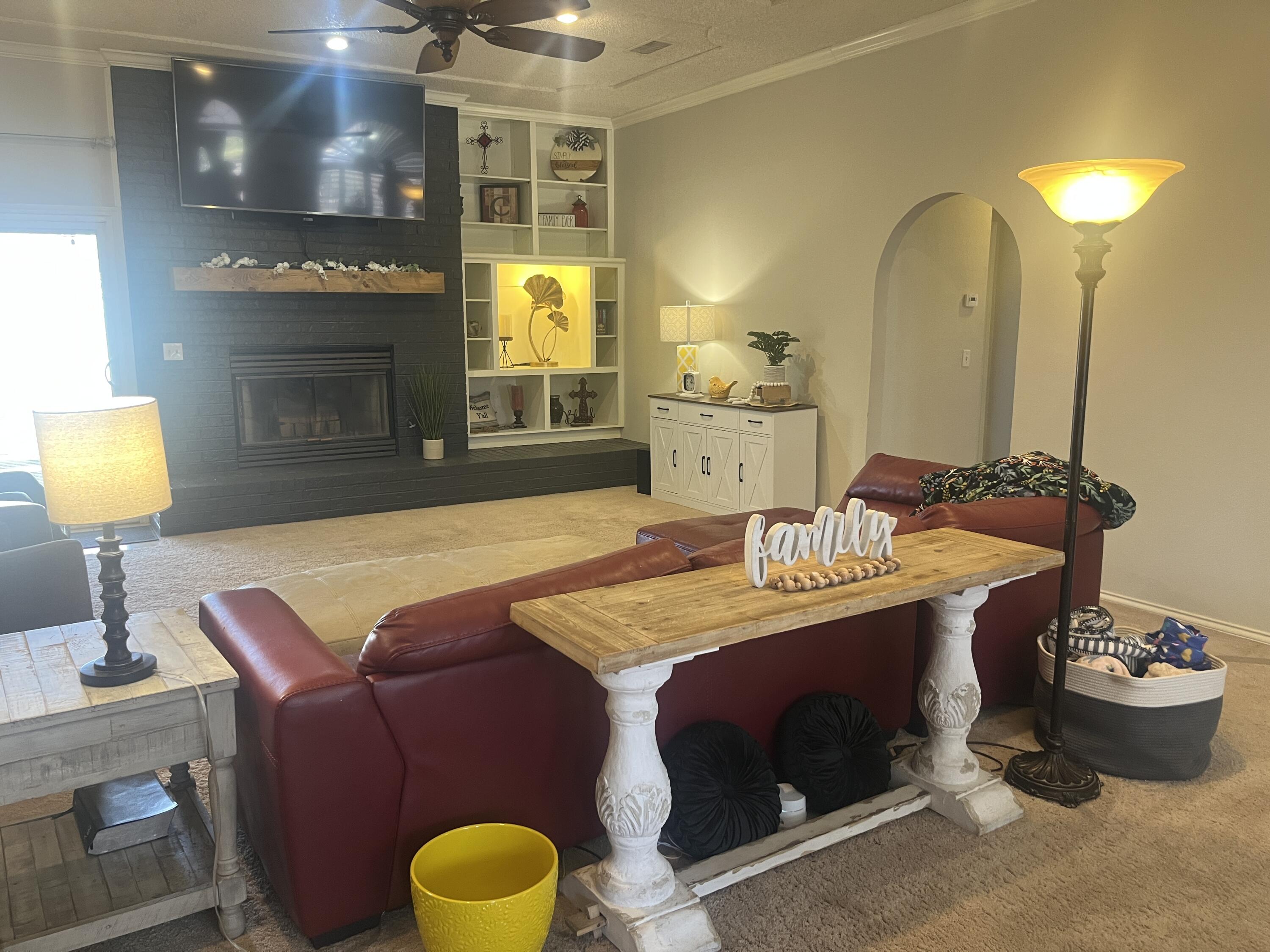 2222 South 2nd Place Lamesa, TX 79331 - Photo 9 of 44 a living room with furniture and a fireplace