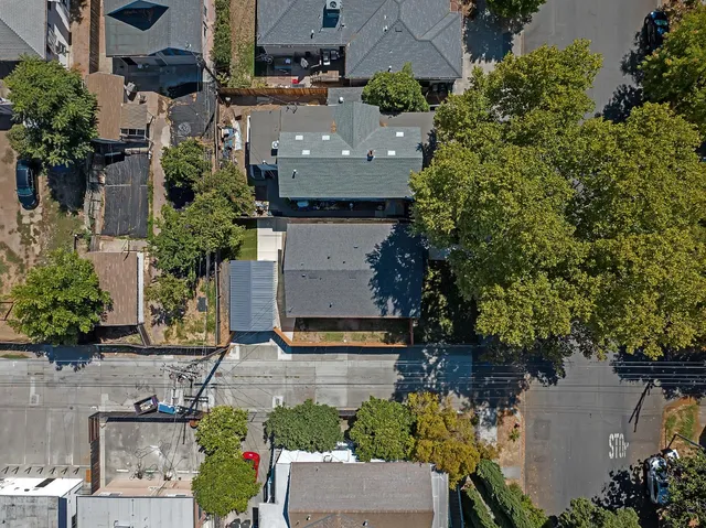 an aerial view of a house with a yard and garden