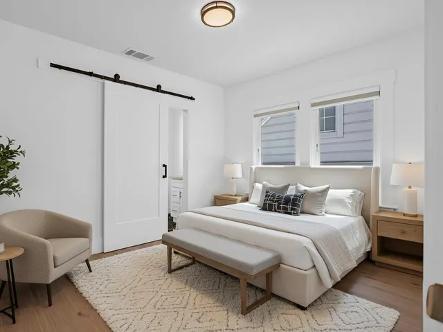 a bedroom with a bed and a chair