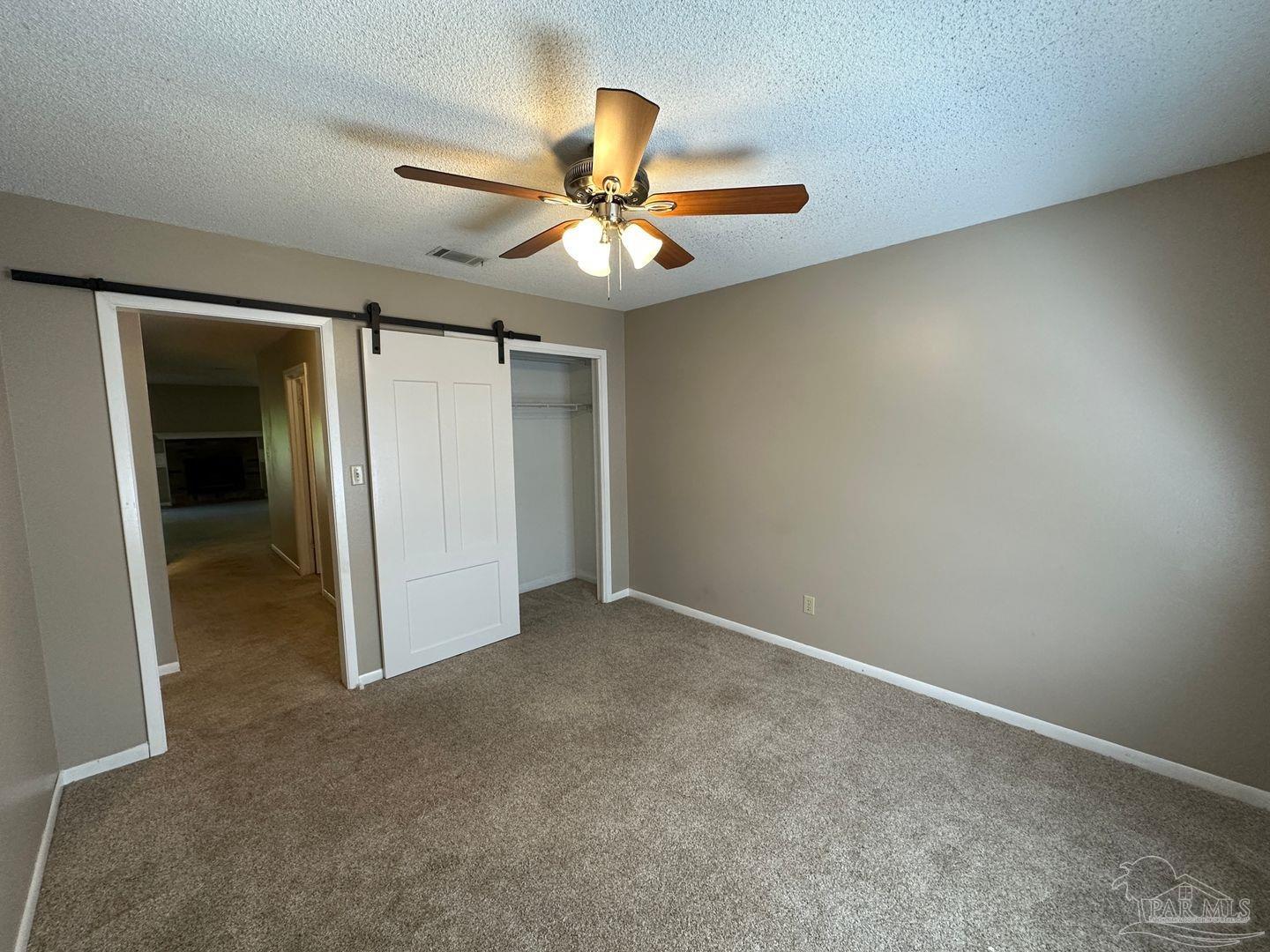 4831 East Olive Road, Unit 4D Pensacola, FL 32514 - Photo 9 of 17 an empty room and chandelier fan