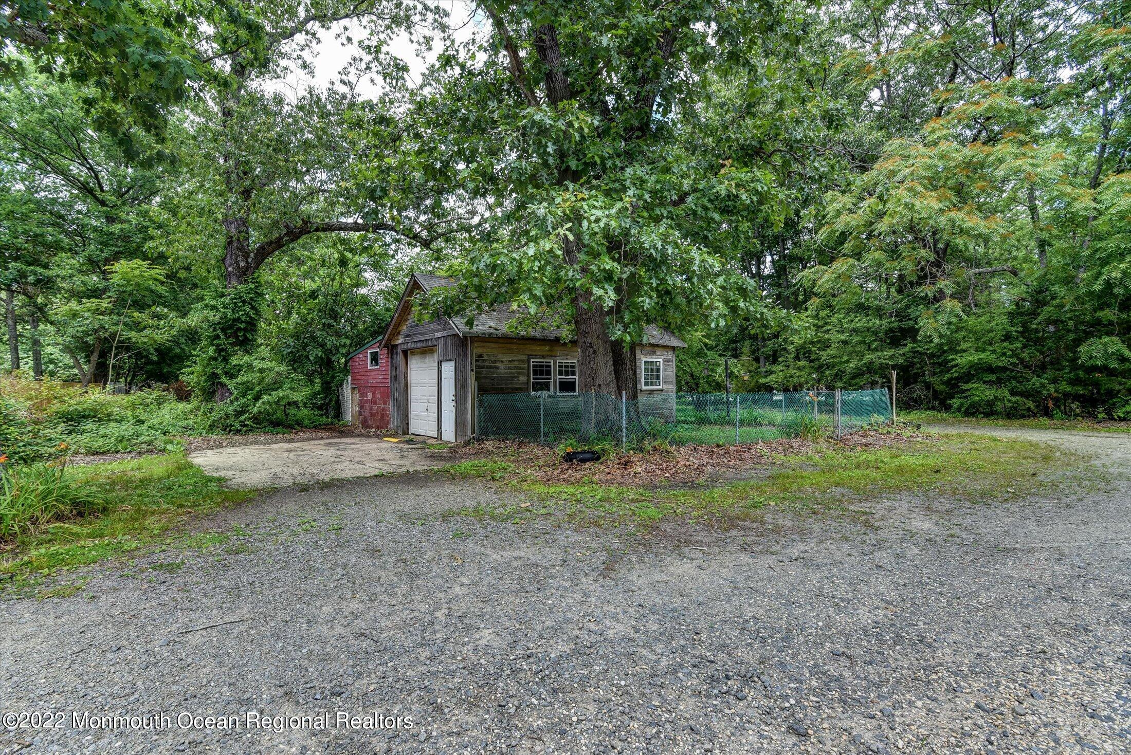 1350 Toms River Road Jackson, NJ 08527 - Photo 9 of 20 a view of a house with a yard and large trees