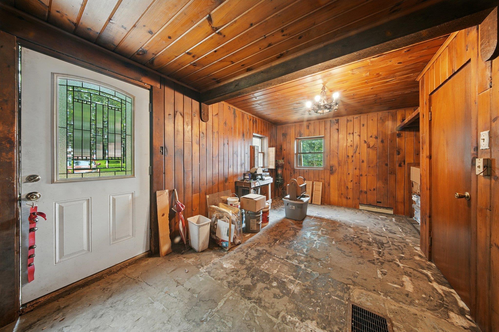 251 Haring Road Barryville, NY 12719 - Photo 11 of 30 Foyer entrance with wooden ceiling, a chandelier, wooden walls, and a baseboard radiator