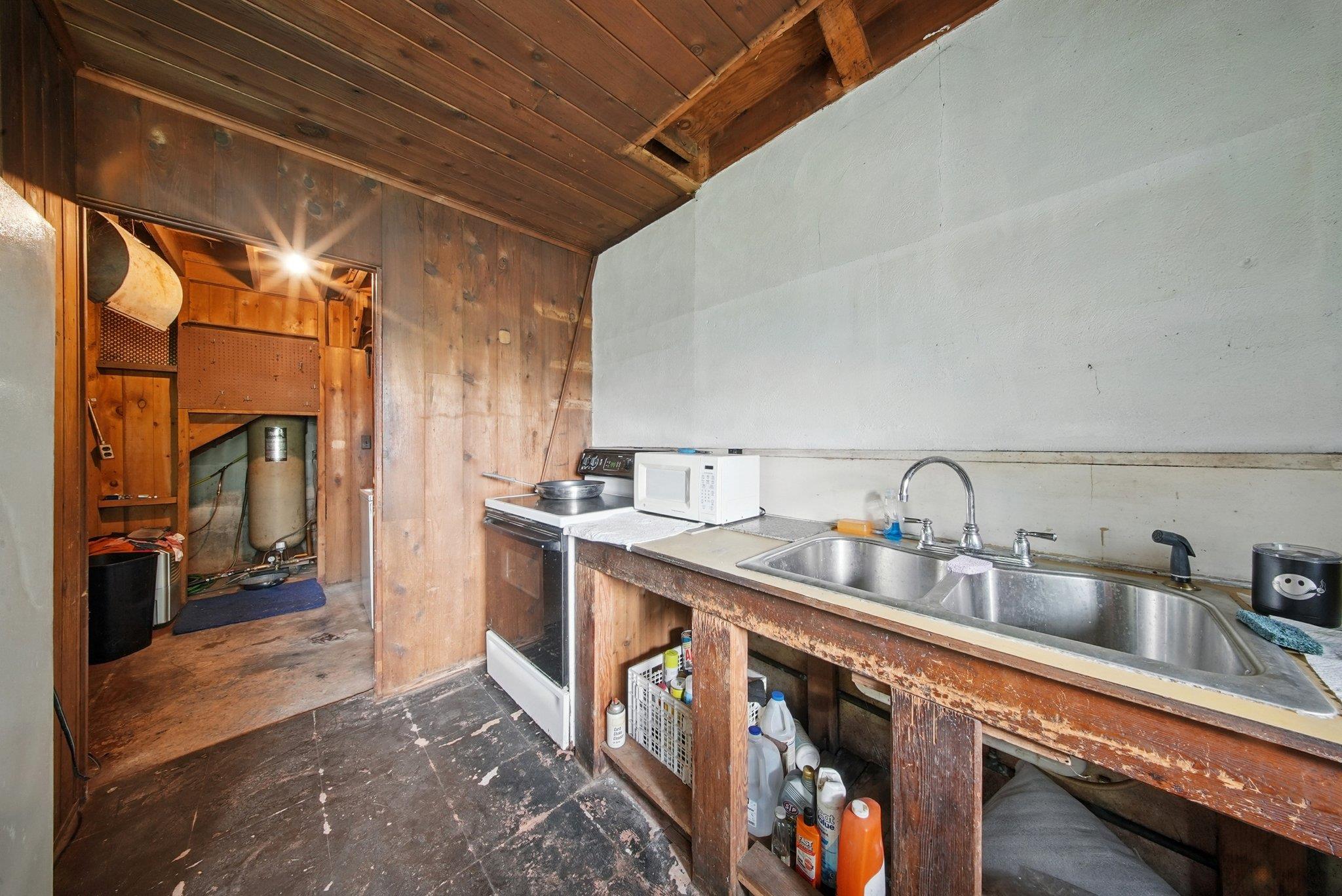 251 Haring Road Barryville, NY 12719 - Photo 8 of 30 Kitchen featuring white appliances, wood ceiling, and wood walls