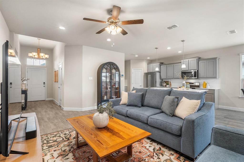 1864 Mensa Drive Haslet, TX 76052 - Photo 13 of 40 a living room with furniture kitchen view and a chandelier