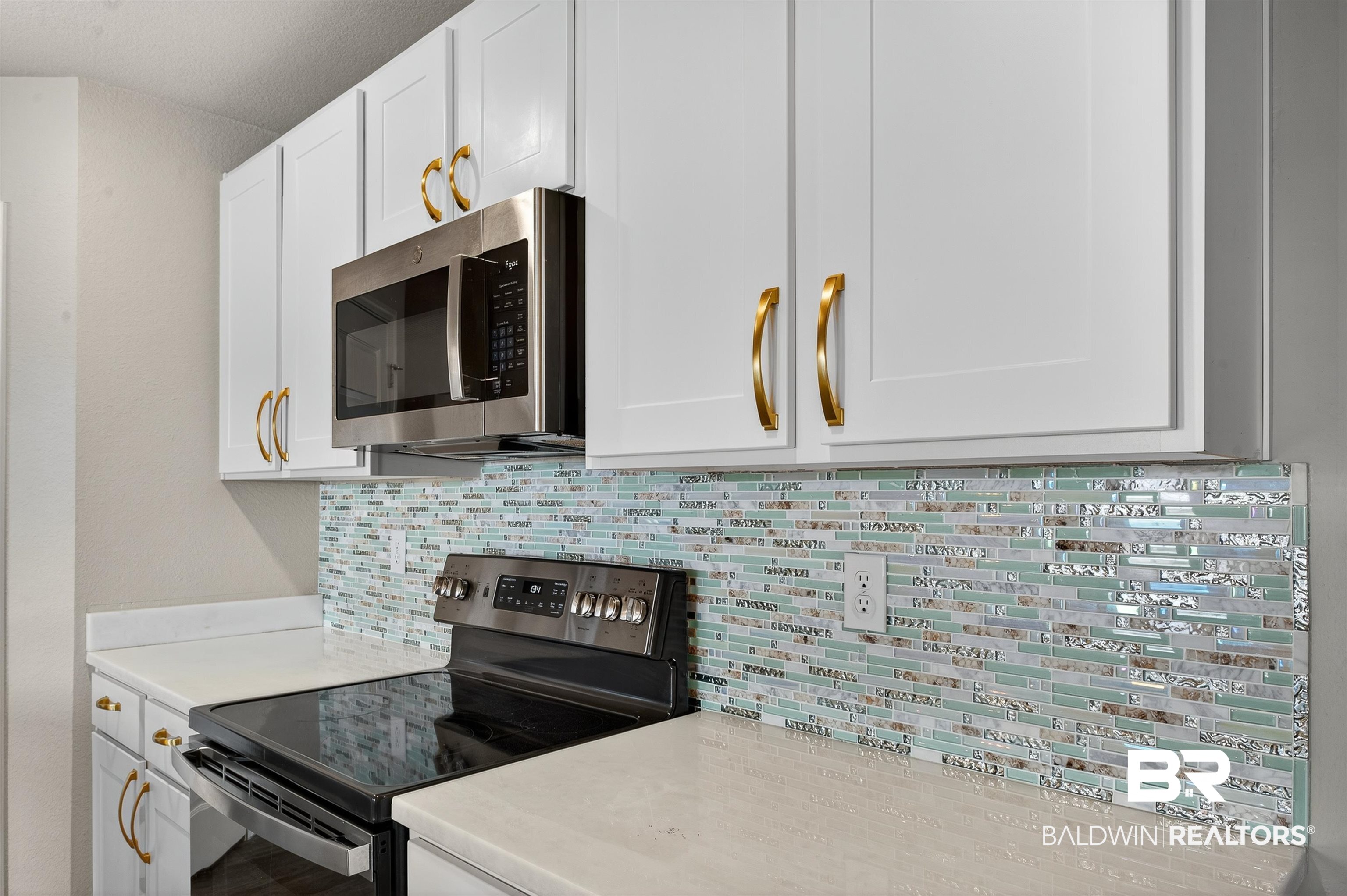 7429 Brompton Drive Foley, AL 36535 - Photo 7 of 50 Kitchen with appliances with stainless steel finishes, tasteful backsplash, and white cabinets