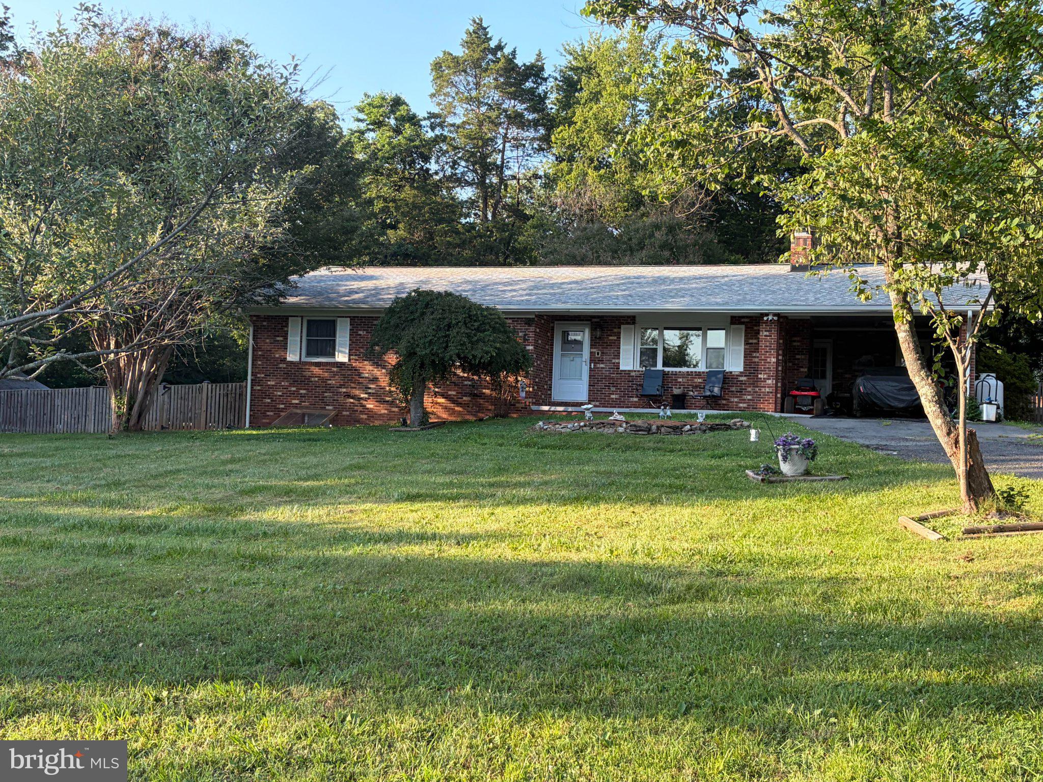 11622 Lucasville Road Manassas, VA 20112 - Photo 1 of 1 Charming brick home with lush greenery.
