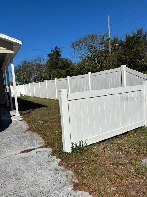 9145 Rally Lane Holiday, FL 34690 - Photo 9 of 14 a view of a backyard with wooden fence