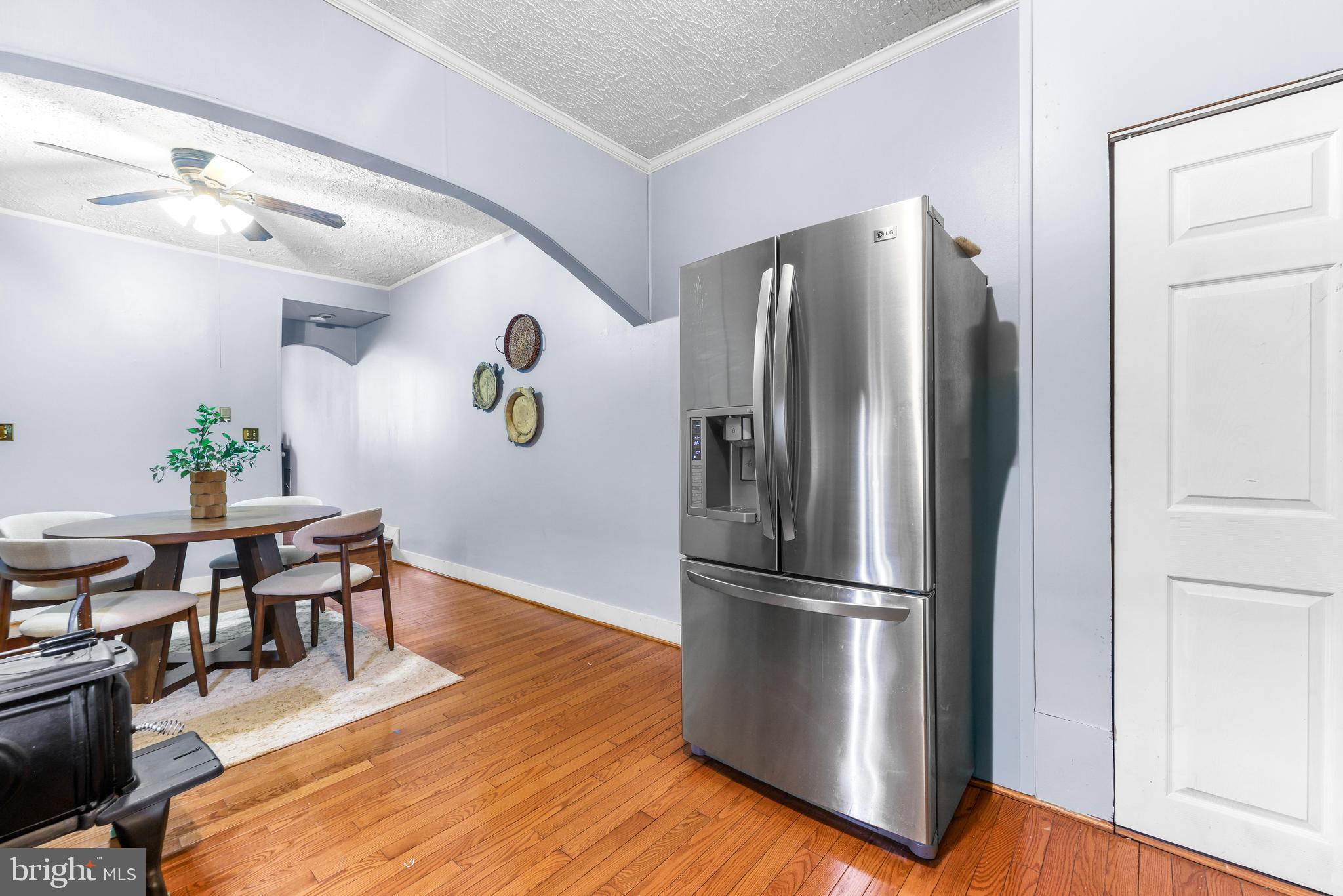 1113 South Robinson Street Baltimore, MD 21224 - Photo 15 of 38 a kitchen with stainless steel appliances granite countertop a refrigerator and a table