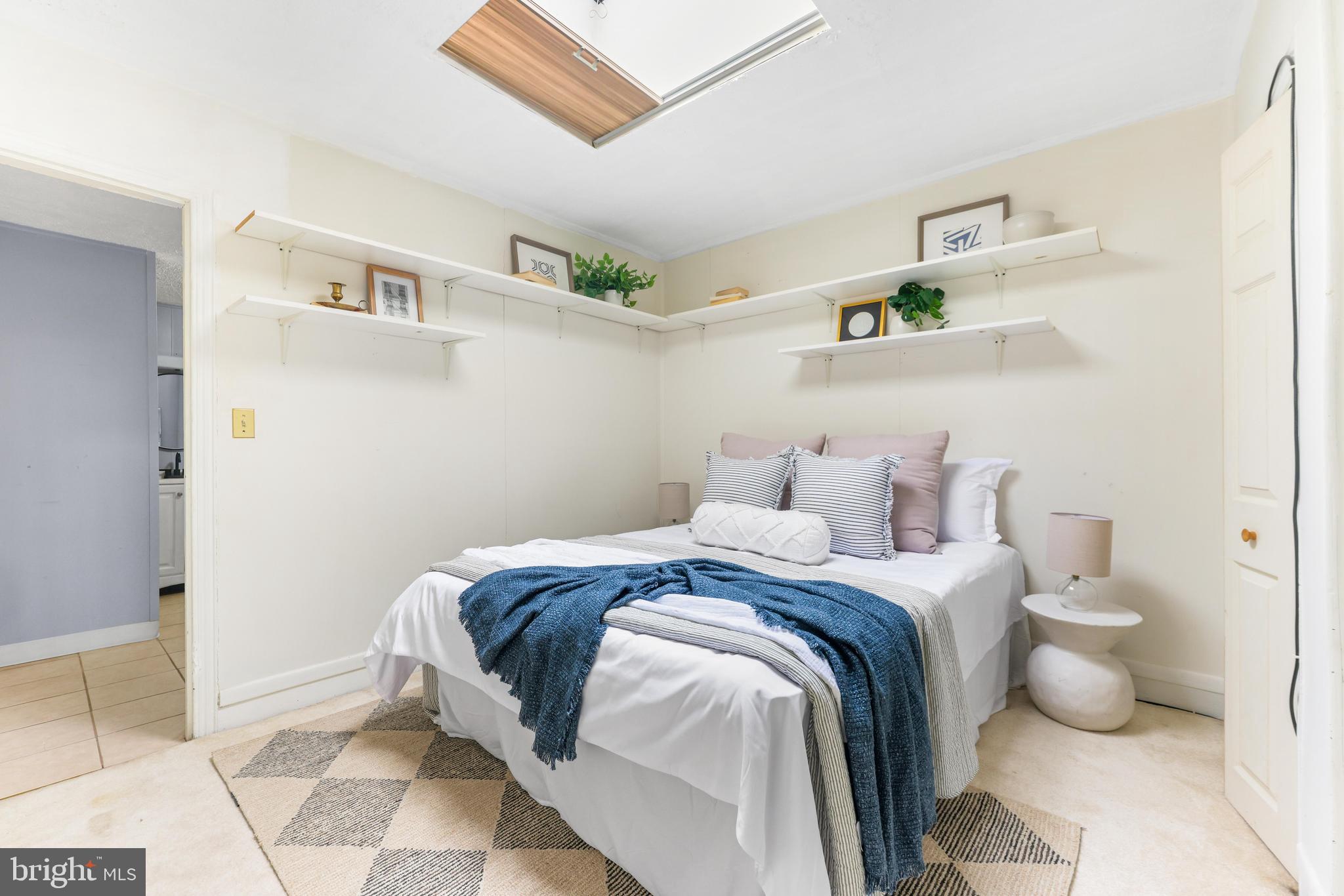 1113 South Robinson Street Baltimore, MD 21224 - Photo 19 of 38 a bedroom with a bed and a potted plant