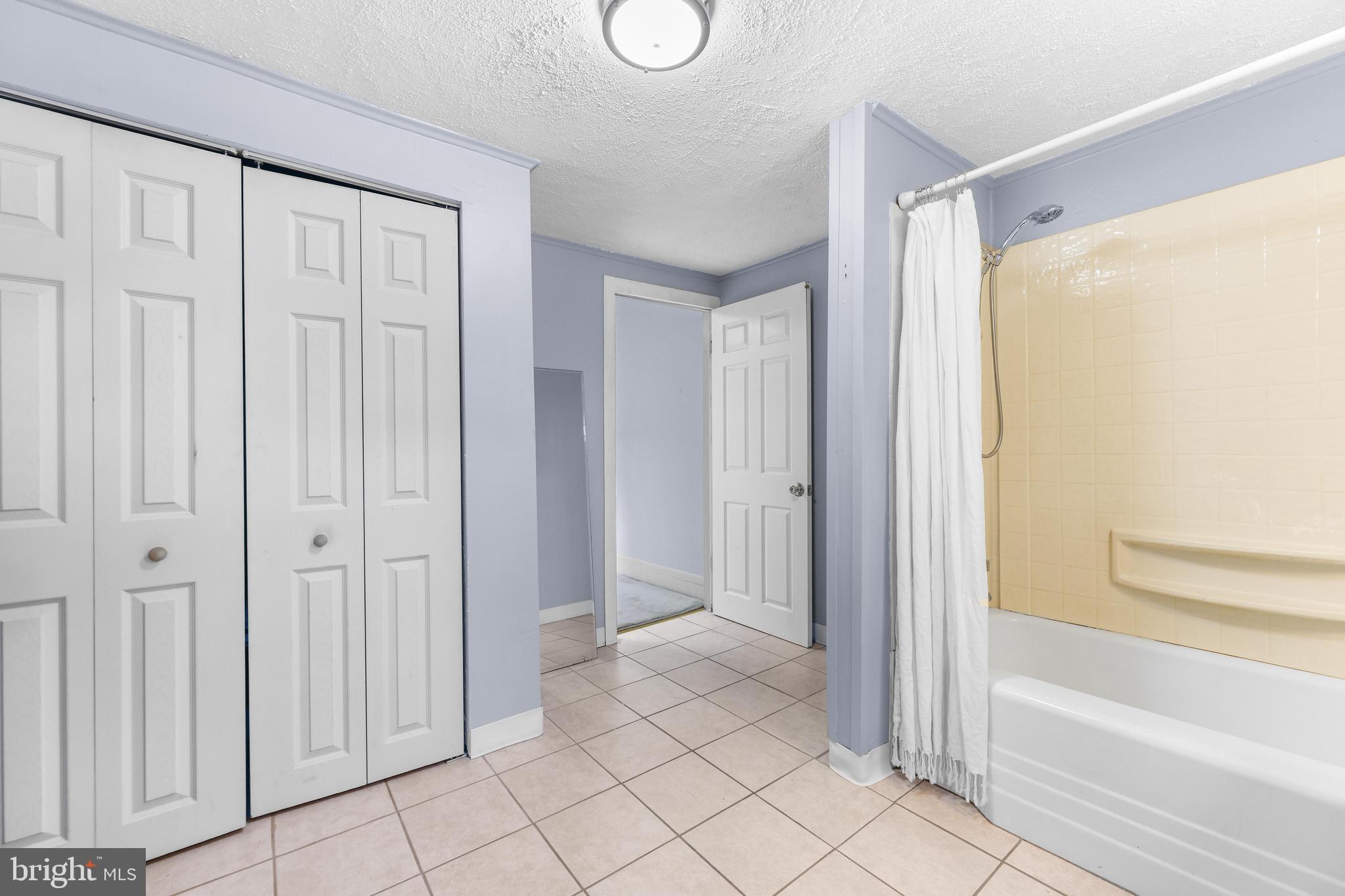 1113 South Robinson Street Baltimore, MD 21224 - Photo 23 of 38 a bathroom with a bathtub and a shower