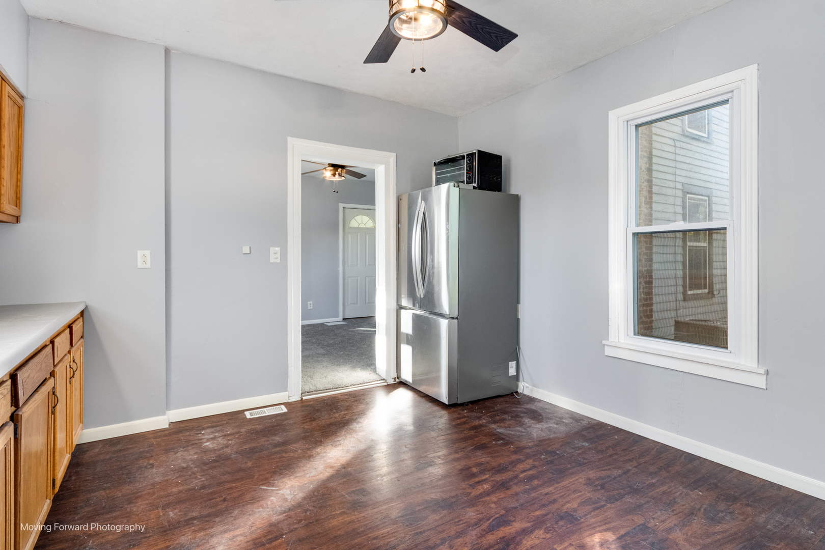 208 West Sycamore Street Millington, IL 60537 - Photo 11 of 19 a view of an empty room with a window and wooden floor