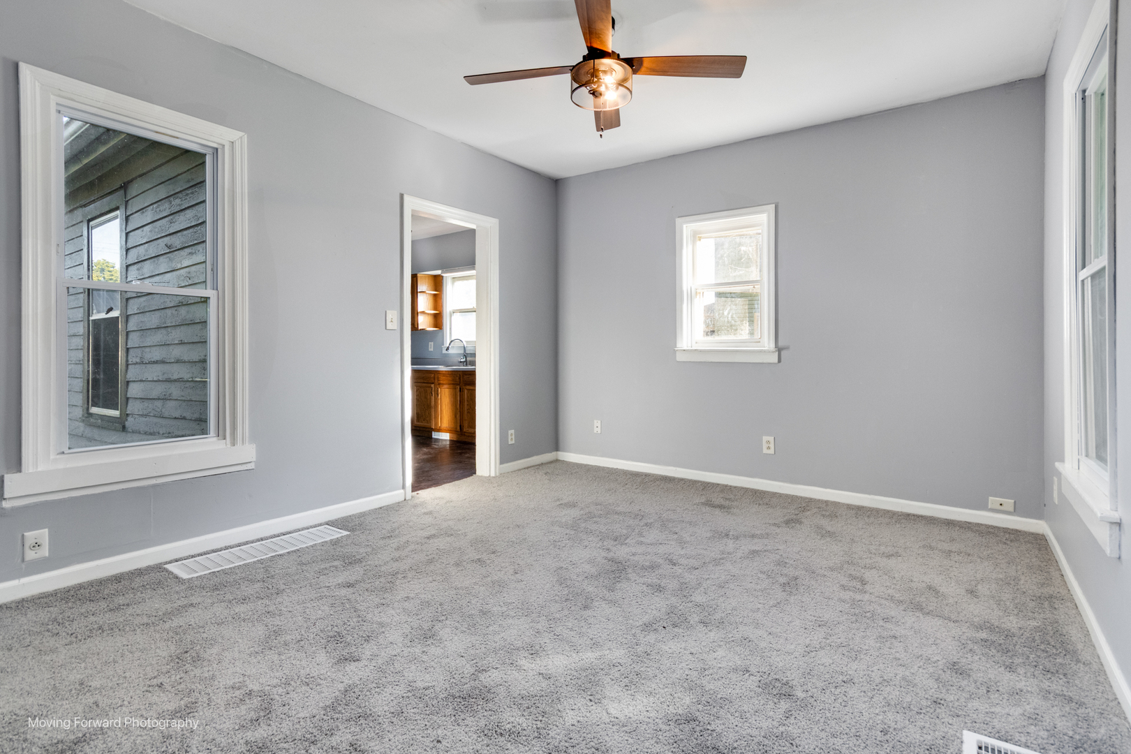 208 West Sycamore Street Millington, IL 60537 - Photo 4 of 19 an empty room with windows and fan