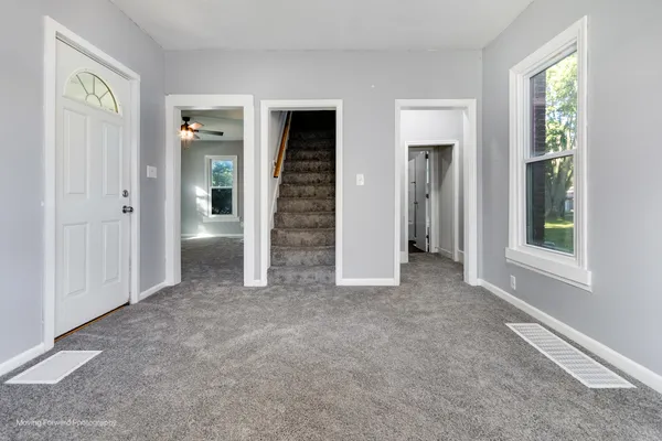 an empty room with windows and closet