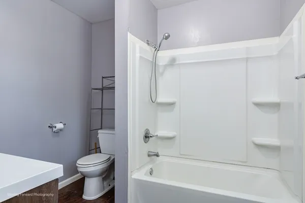 a bathroom with a toilet and a bathtub
