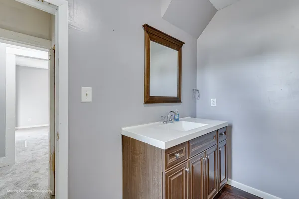 a bathroom with a sink a mirror and a toilet