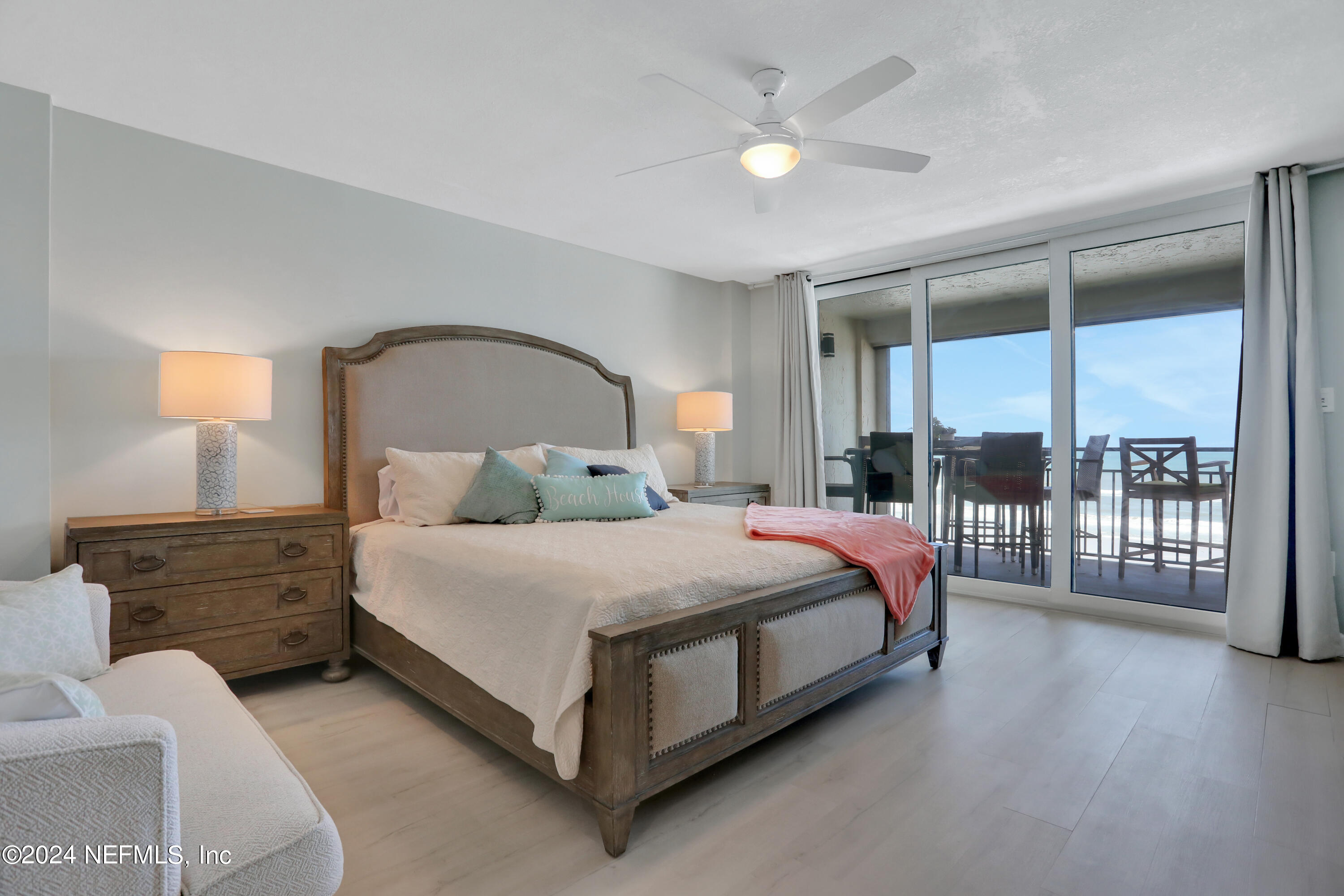 8050 A1A South, Unit 503 St. Augustine, FL 32080 - Photo 16 of 46 a bedroom with a bed a lamp and window