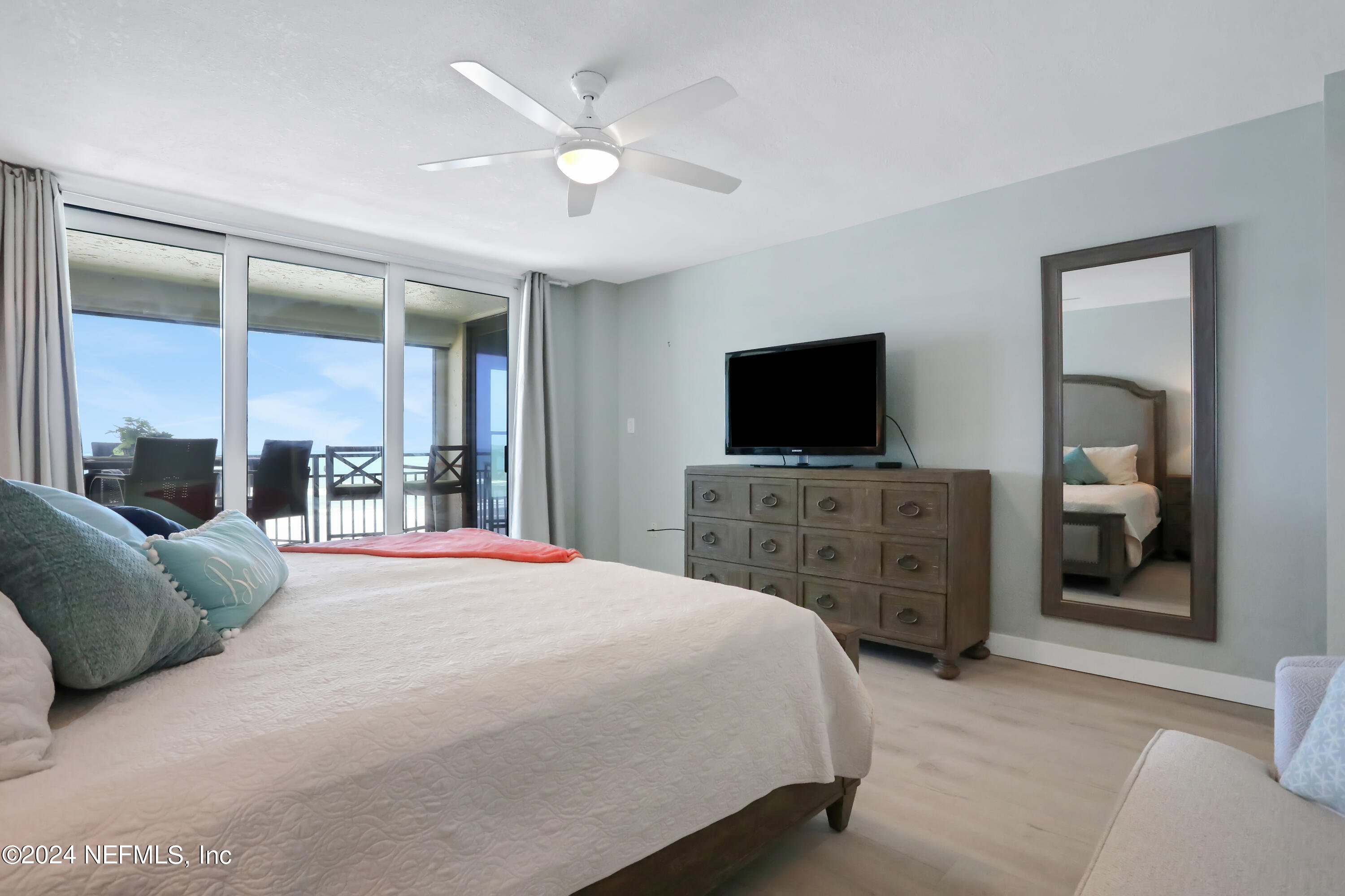 8050 A1A South, Unit 503 St. Augustine, FL 32080 - Photo 17 of 46 a bedroom with a bed and a flat screen tv
