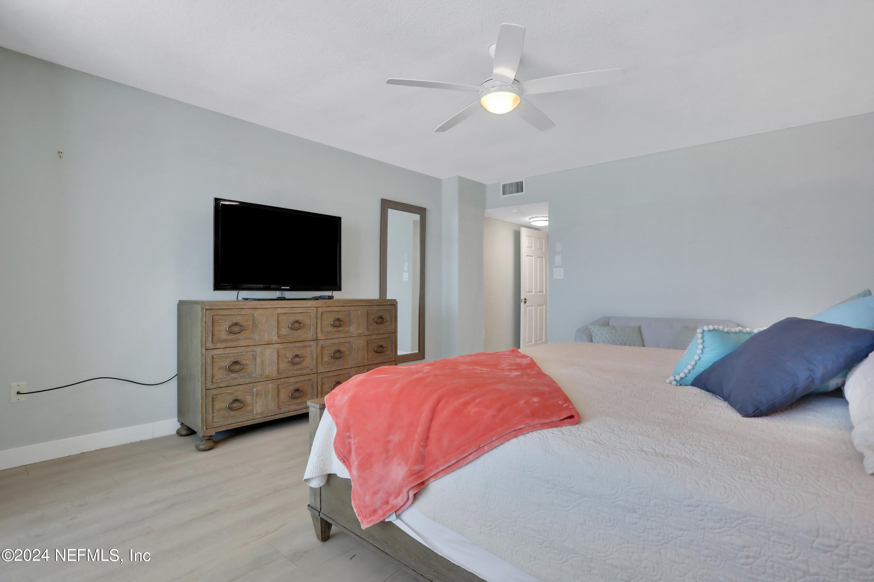 8050 A1A South, Unit 503 St. Augustine, FL 32080 - Photo 18 of 46 a bedroom with a bed and a flat screen tv