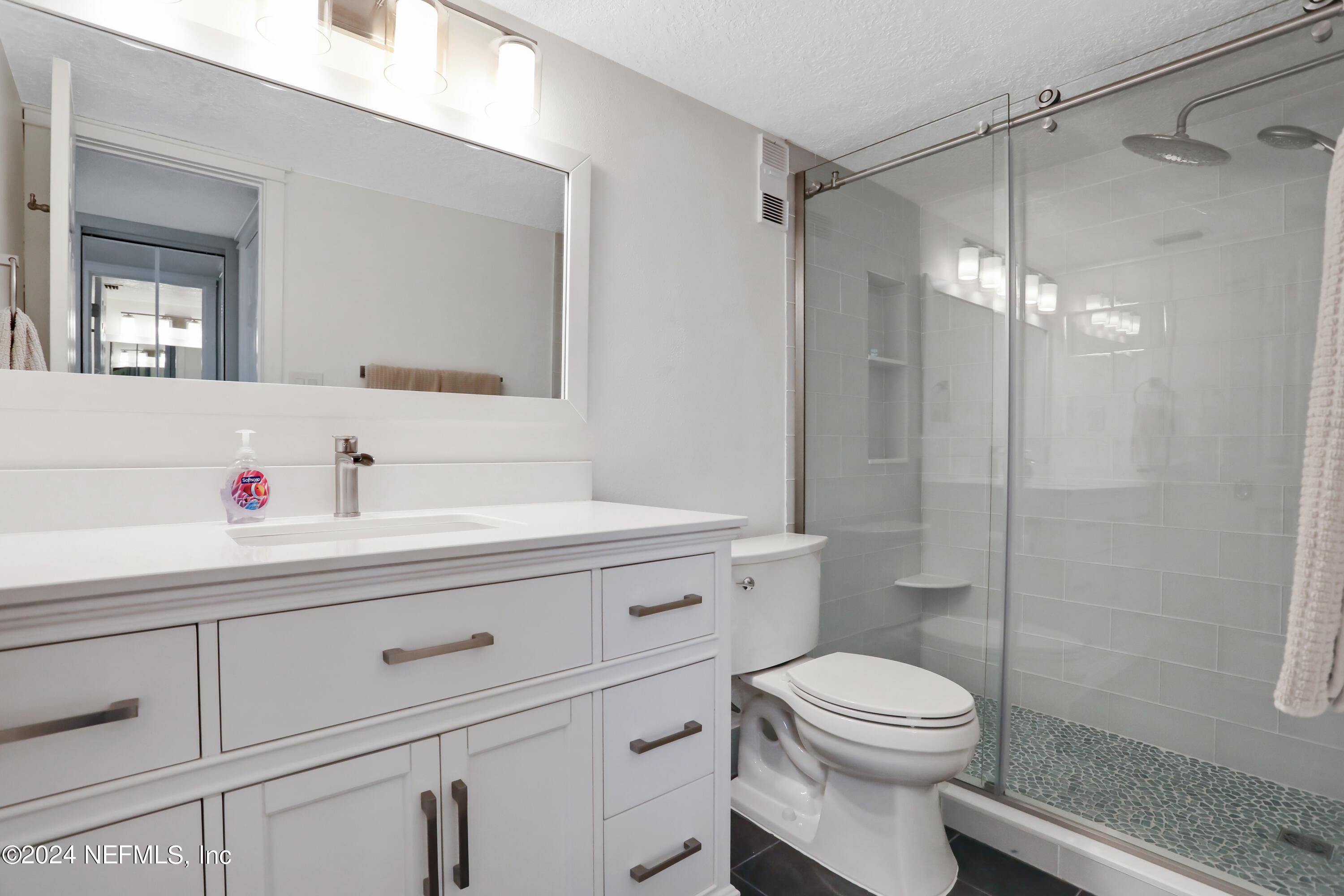 8050 A1A South, Unit 503 St. Augustine, FL 32080 - Photo 19 of 46 a bathroom with a sink a toilet and shower