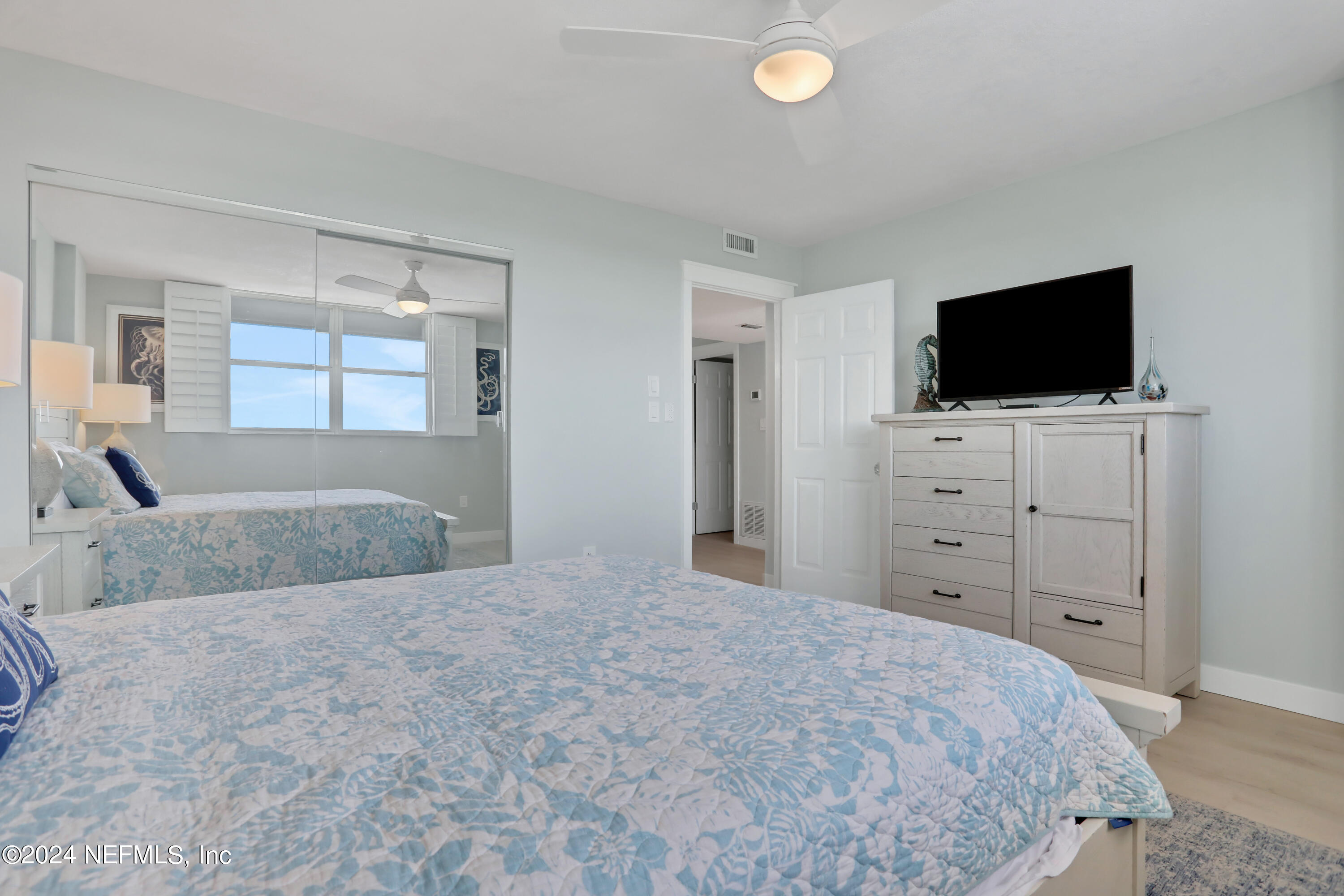 8050 A1A South, Unit 503 St. Augustine, FL 32080 - Photo 20 of 46 a bedroom with a bed and a flat screen tv
