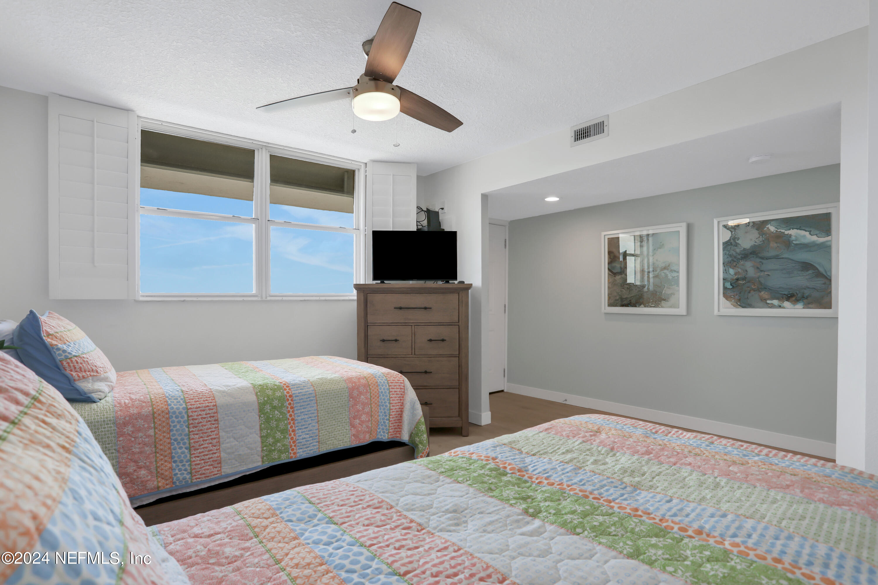8050 A1A South, Unit 503 St. Augustine, FL 32080 - Photo 22 of 46 a bedroom with a bed and a television