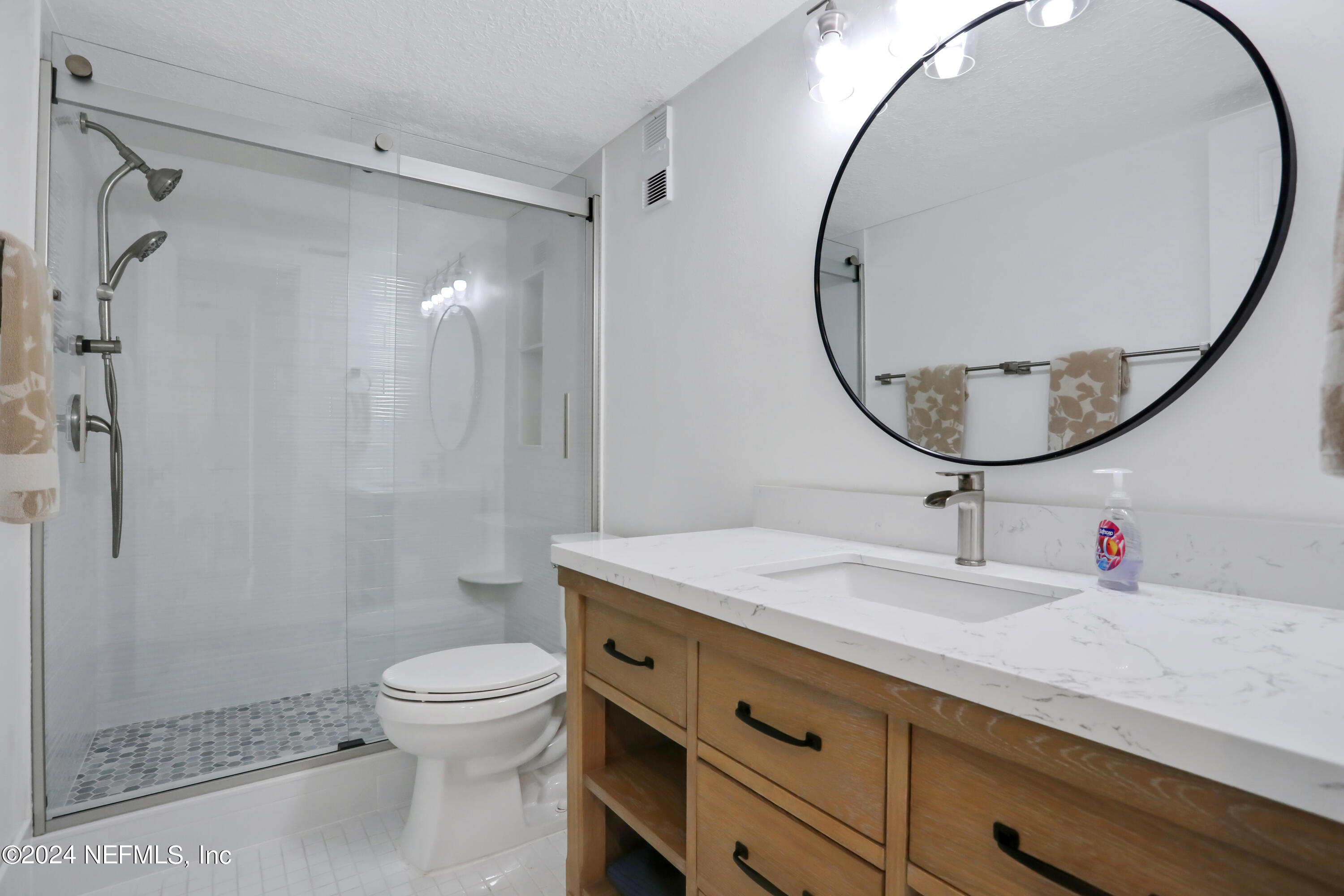 8050 A1A South, Unit 503 St. Augustine, FL 32080 - Photo 23 of 46 a bathroom with a sink a toilet and a mirror