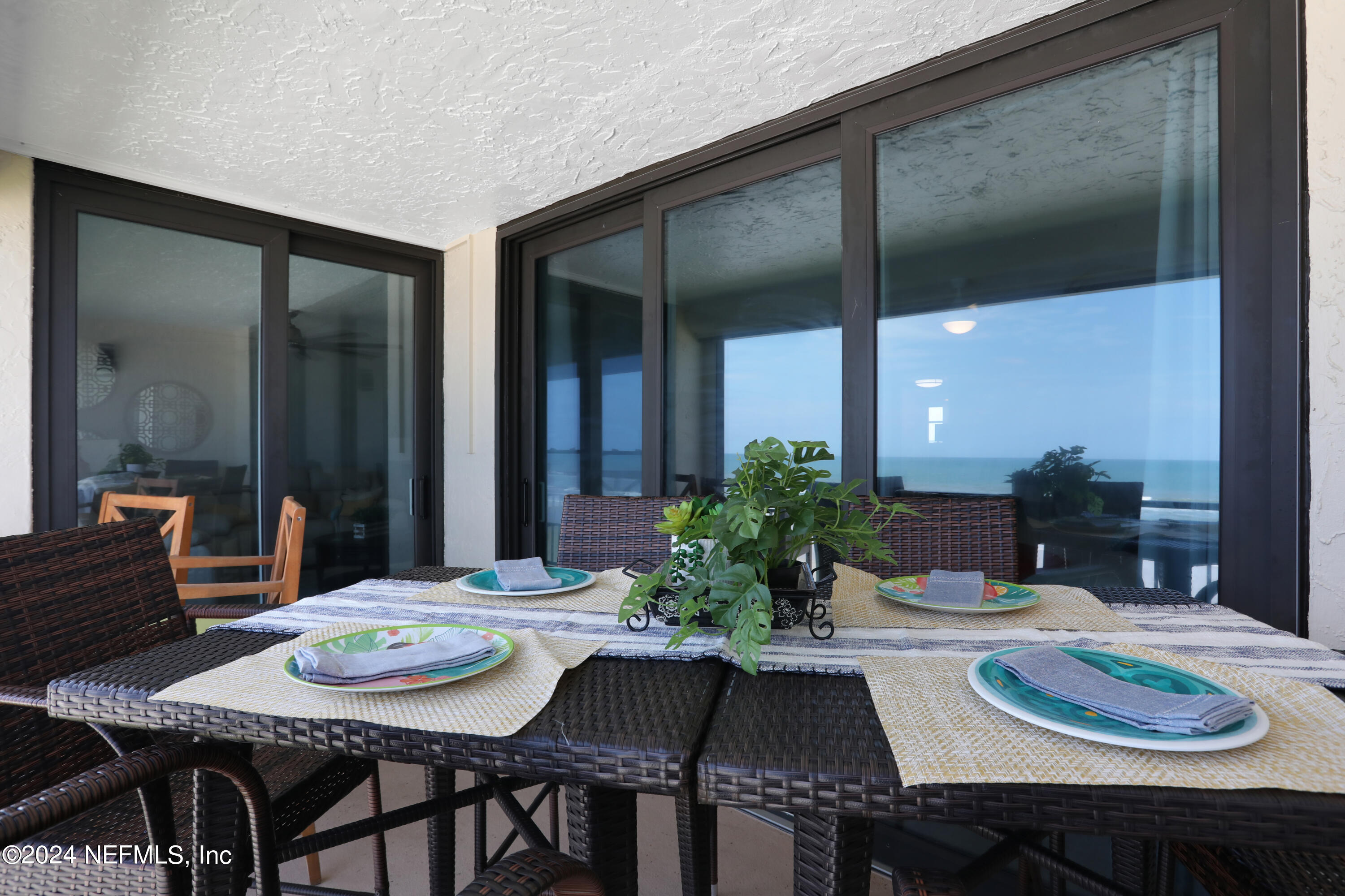 8050 A1A South, Unit 503 St. Augustine, FL 32080 - Photo 27 of 46 a outdoor dining space with furniture and a potted plant