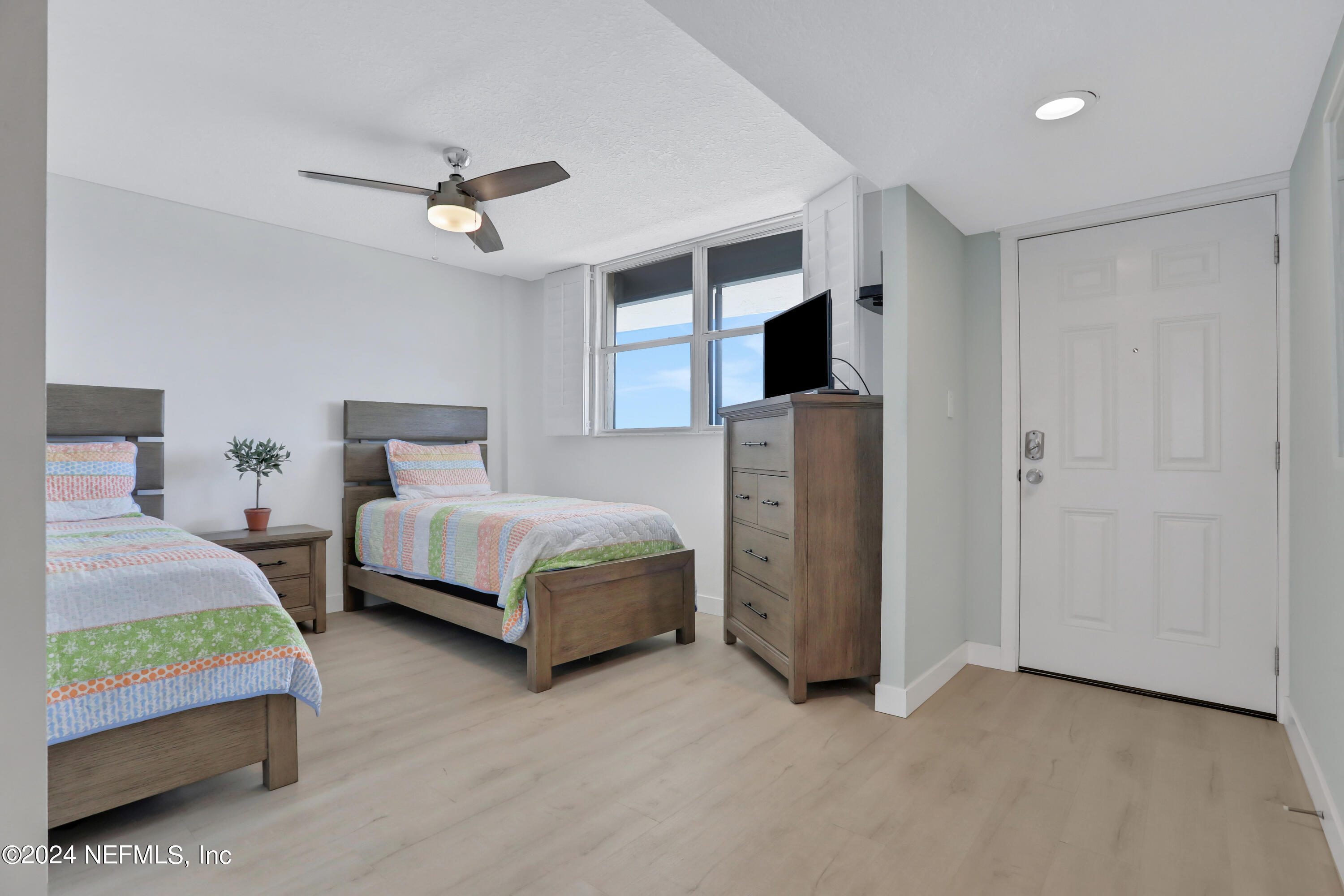 8050 A1A South, Unit 503 St. Augustine, FL 32080 - Photo 4 of 46 a bedroom with a bed and a chandelier