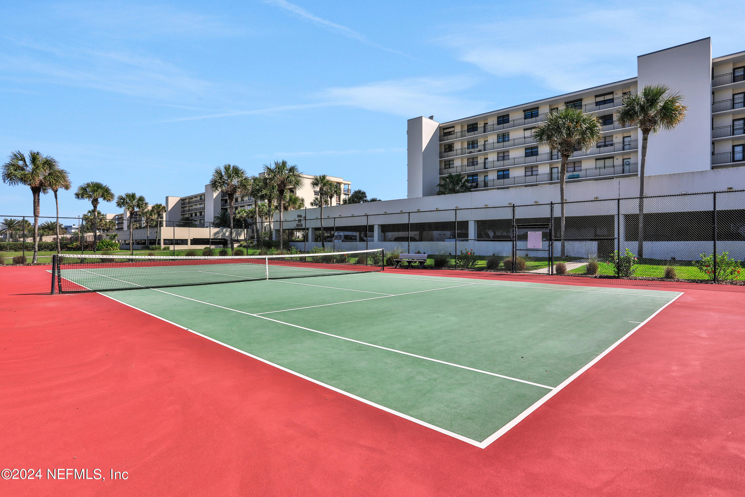 8050 A1A South, Unit 503 St. Augustine, FL 32080 - Photo 43 of 46 a view of a tennis ground with large trees