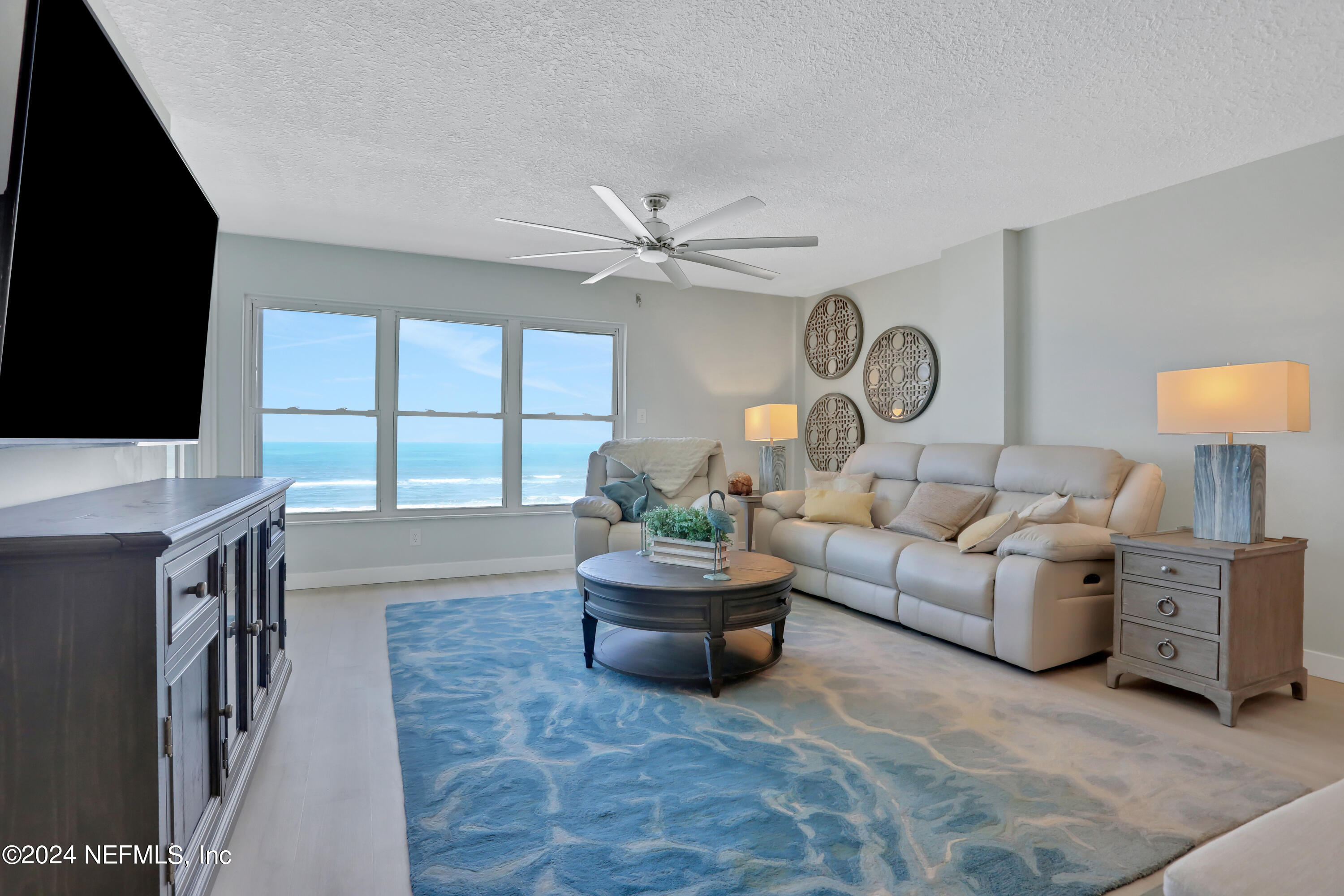 8050 A1A South, Unit 503 St. Augustine, FL 32080 - Photo 8 of 46 a living room with furniture and a flat screen tv