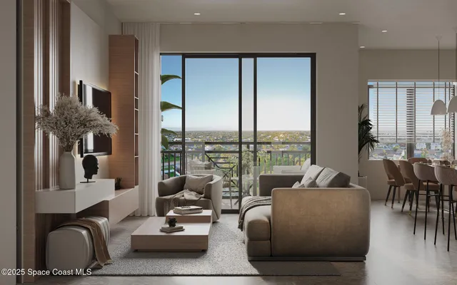 a living room with furniture and floor to ceiling windows
