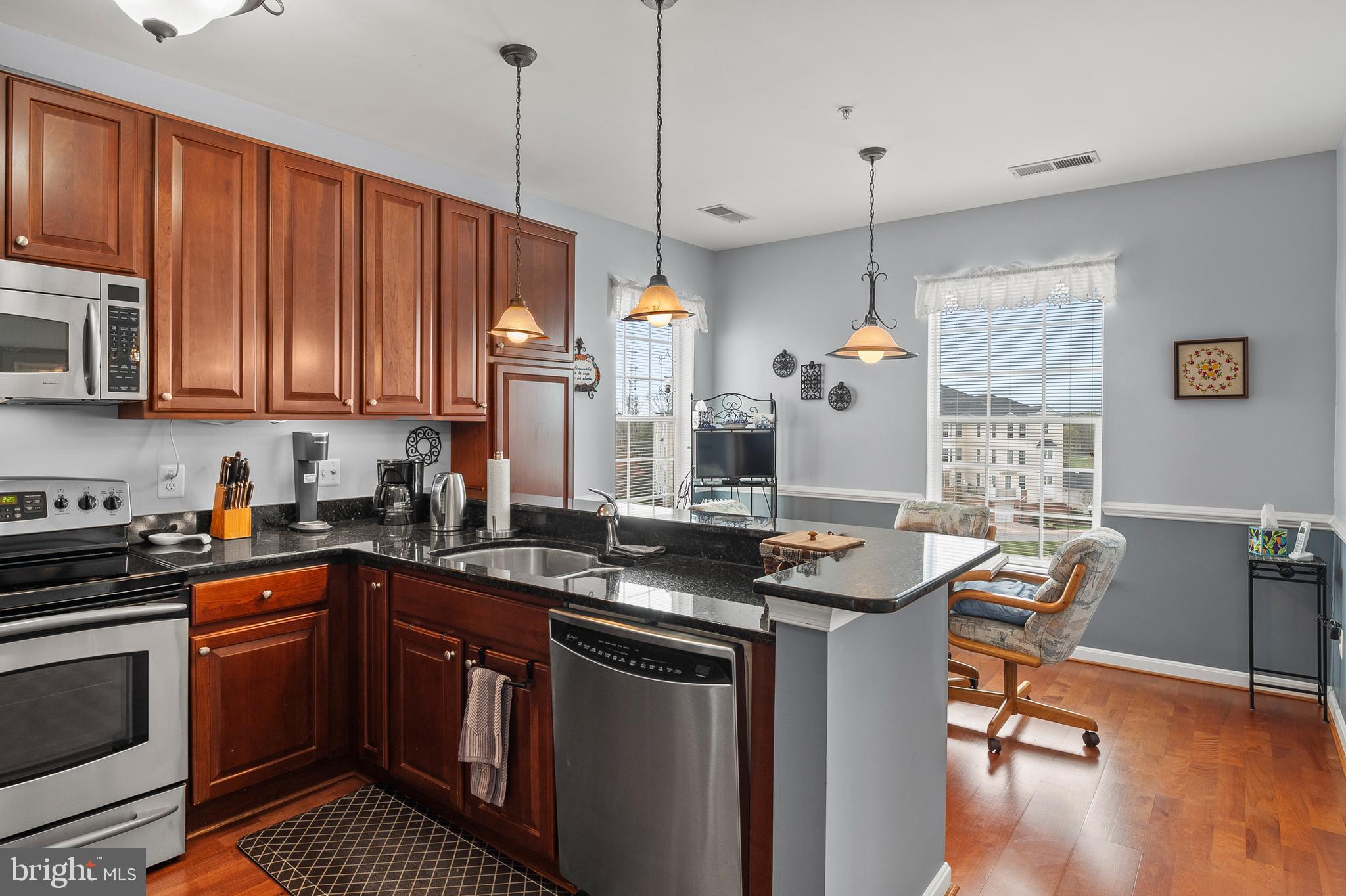7305 Maplecrest Road, Unit 402 Elkridge, MD 21075 - Photo 14 of 55 a kitchen with a sink stove and cabinets