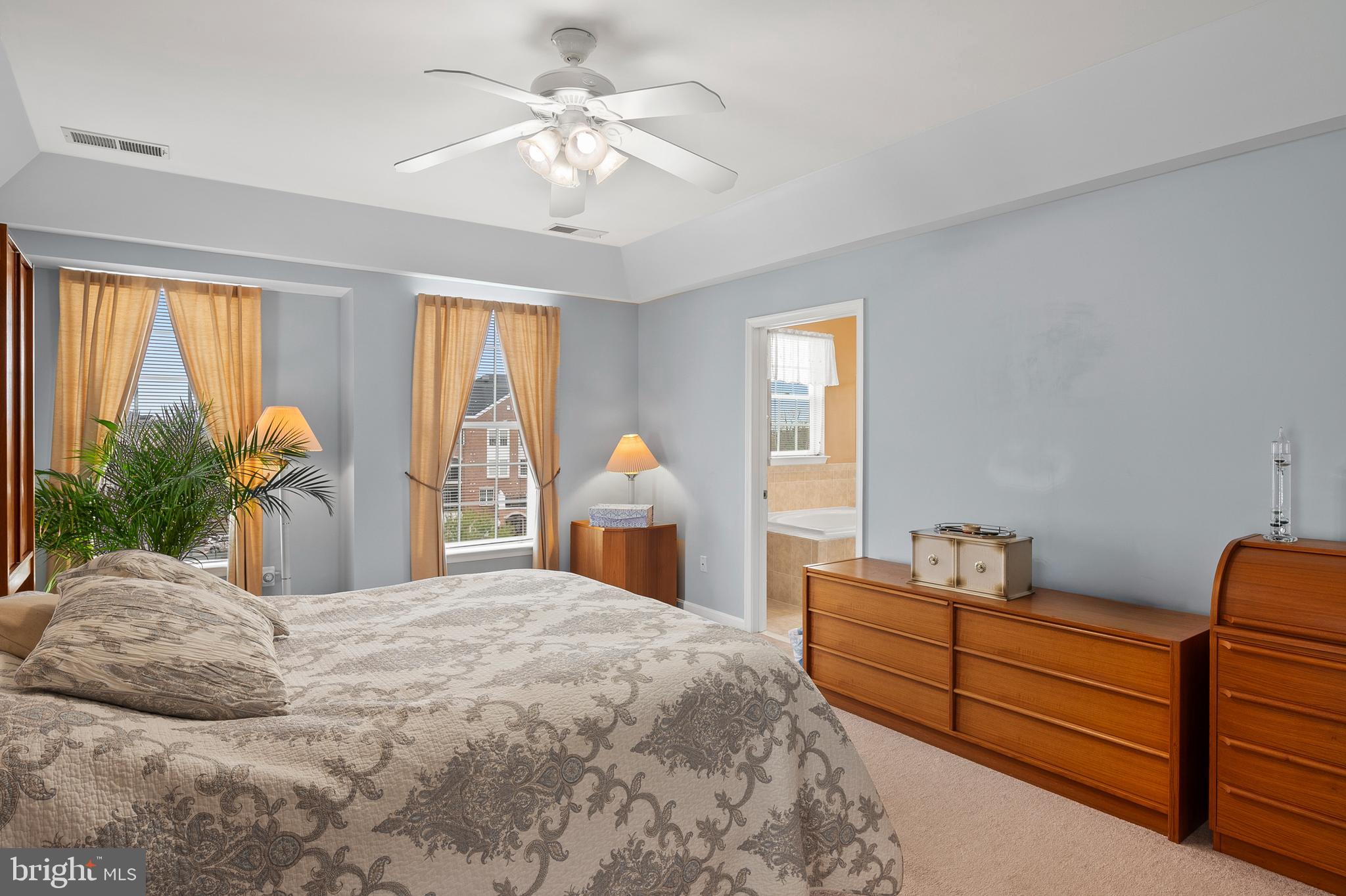 7305 Maplecrest Road, Unit 402 Elkridge, MD 21075 - Photo 18 of 55 a bedroom with a large bed and a chandelier