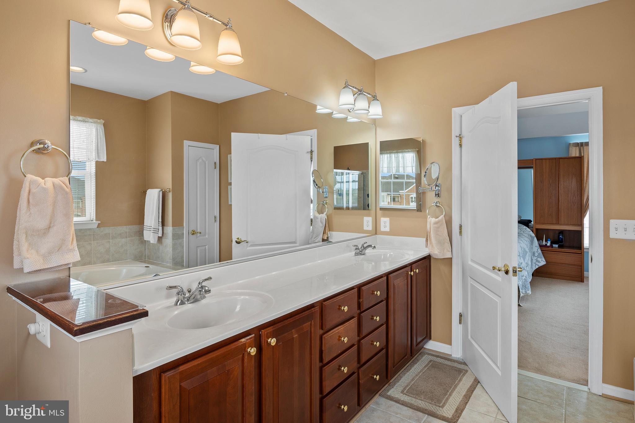 7305 Maplecrest Road, Unit 402 Elkridge, MD 21075 - Photo 19 of 55 a bathroom with a sink double vanity granite and a mirror