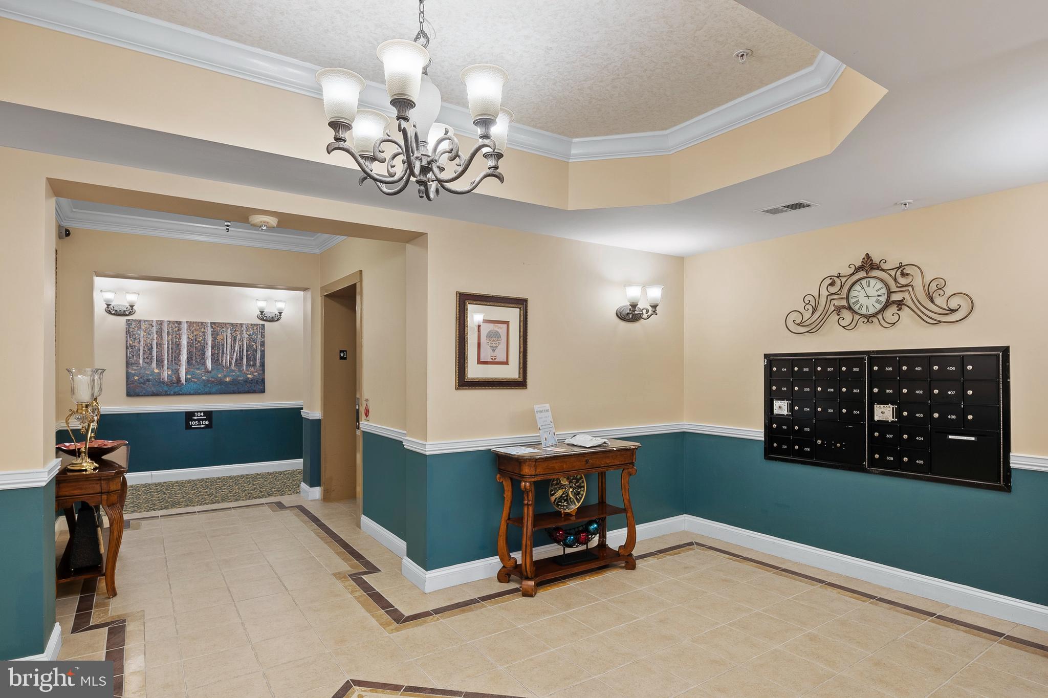 7305 Maplecrest Road, Unit 402 Elkridge, MD 21075 - Photo 3 of 55 a view of a room with gym equipment and a chandelier