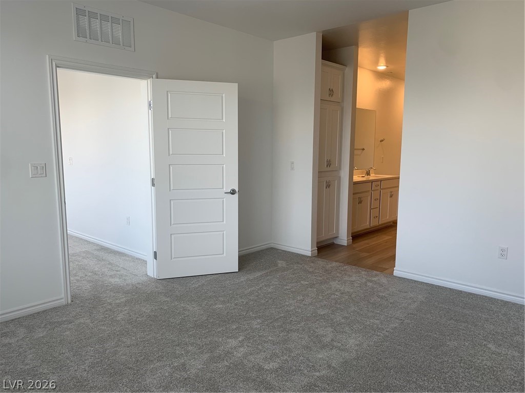 2555 Hampton Road, Unit 7109 Henderson, NV 89052 - Photo 18 of 34 A well-maintained interior offers practical storage solutions with sleek cabinetry and a classic five-panel door.