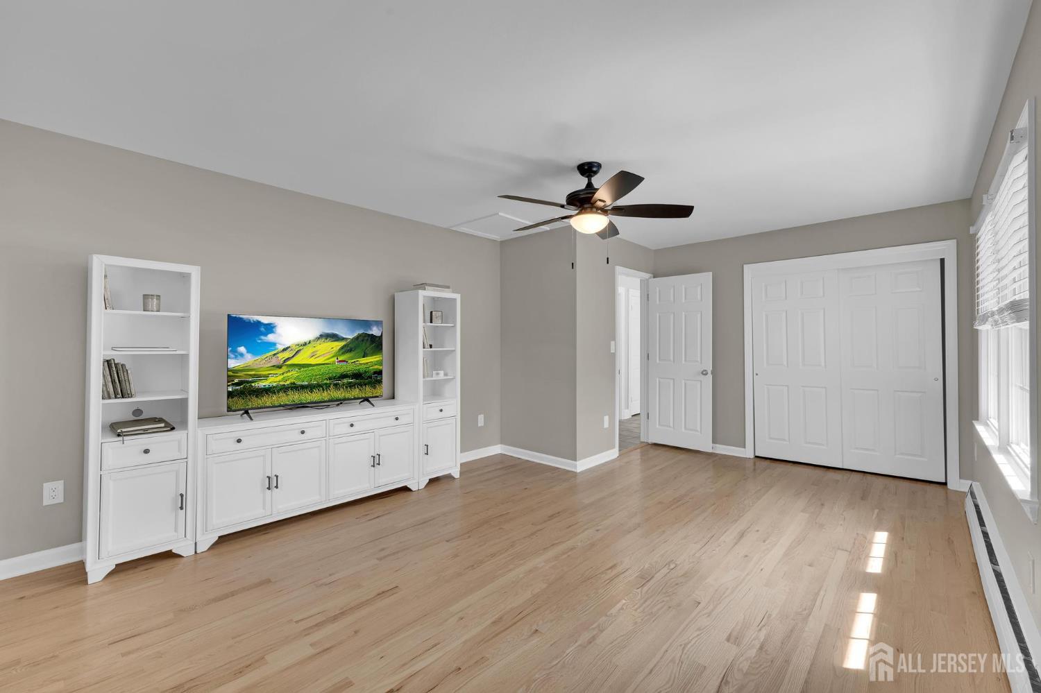 205 Hockenbury Road Hillsborough, NJ 08844 - Photo 22 of 38 a view of an empty room with wooden floor and cabinet