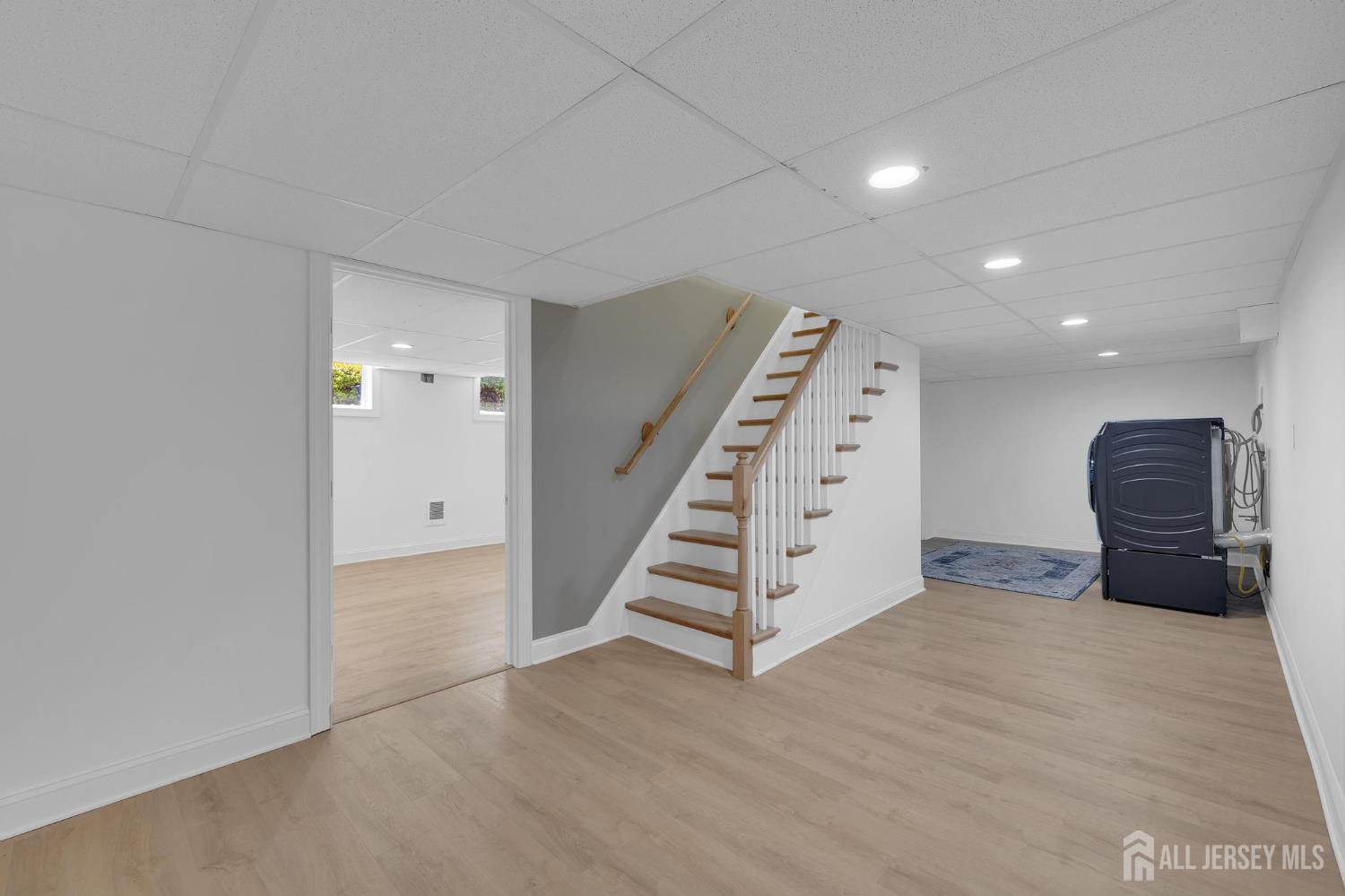 205 Hockenbury Road Hillsborough, NJ 08844 - Photo 28 of 38 a view of an empty room with wooden floor and stairs