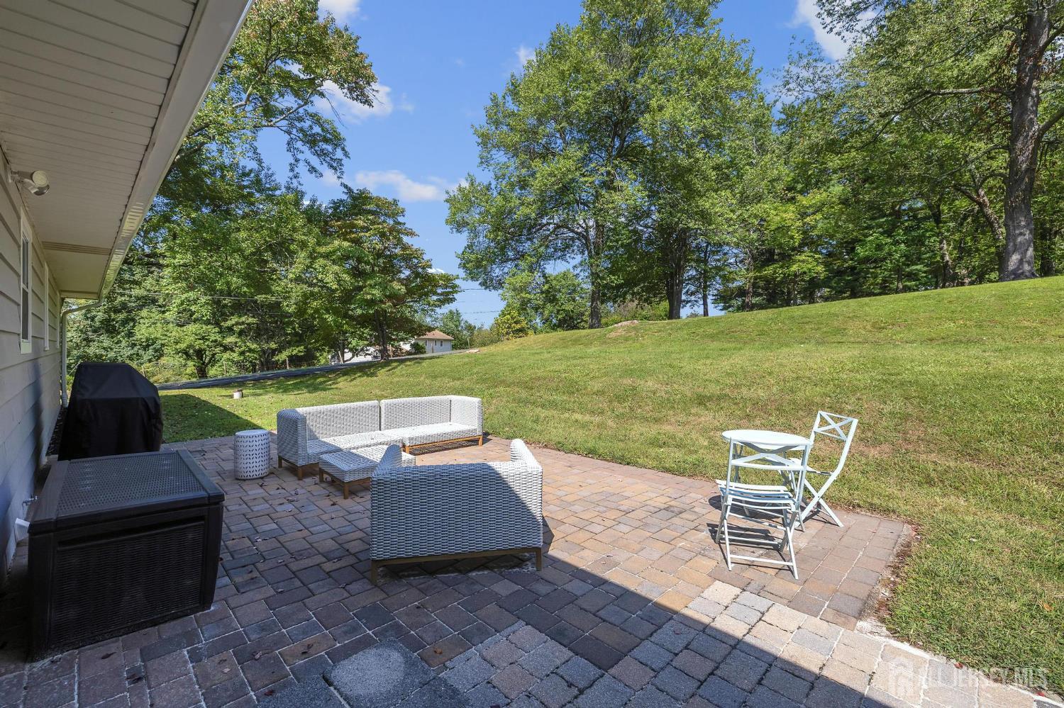 205 Hockenbury Road Hillsborough, NJ 08844 - Photo 36 of 38 a view of a patio with table and chairs and potted plants
