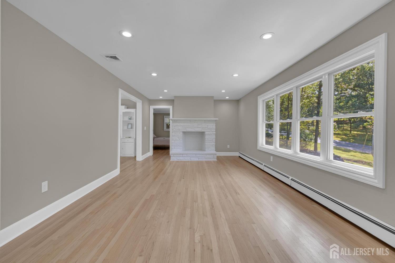 205 Hockenbury Road Hillsborough, NJ 08844 - Photo 7 of 38 a view of an empty room with a window and a kitchen