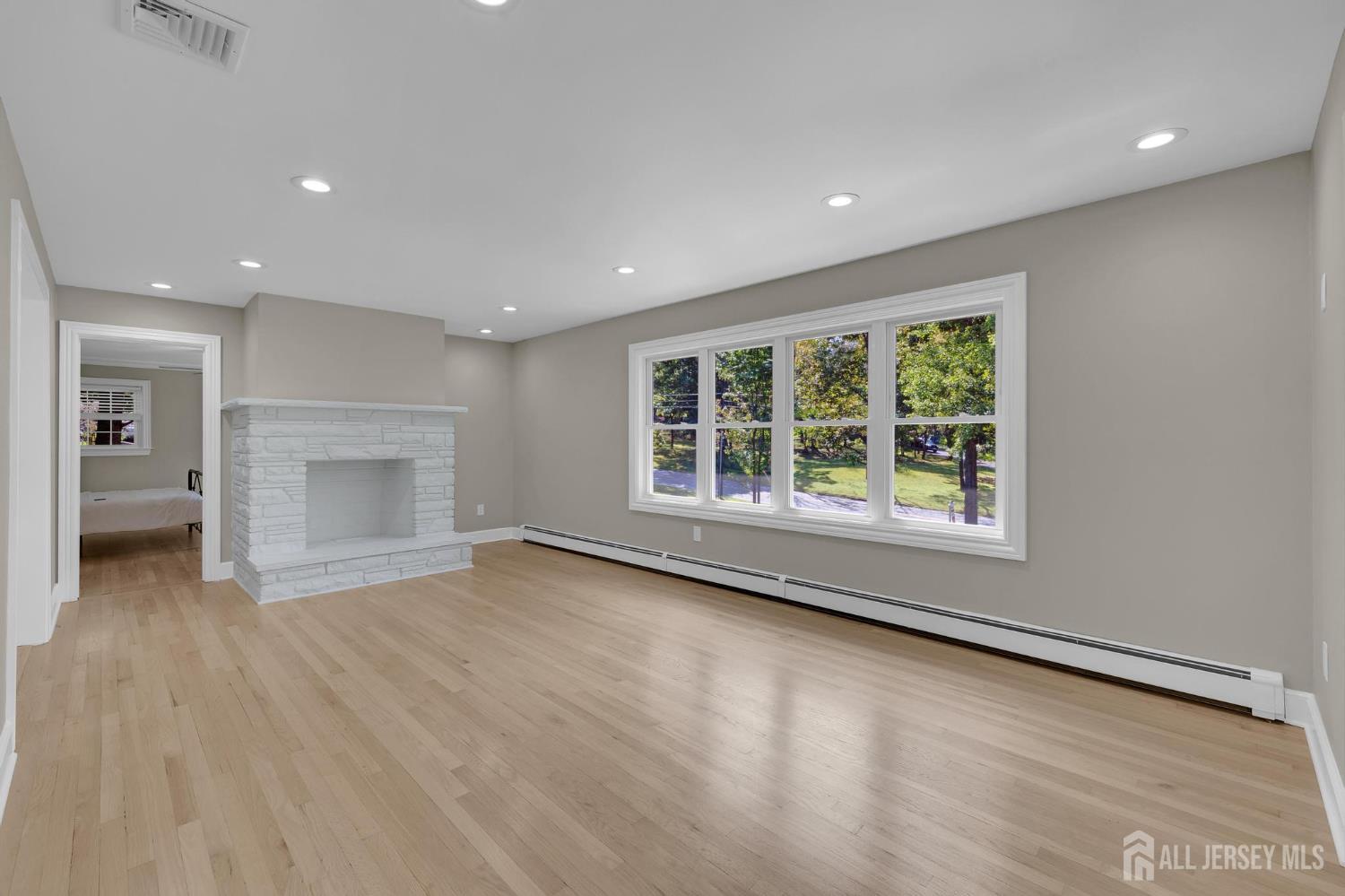 205 Hockenbury Road Hillsborough, NJ 08844 - Photo 8 of 38 an empty room with wooden floor and a window