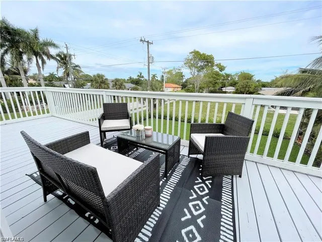a view of a balcony with wooden floor and outdoor seating