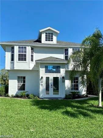 a front view of a house with a garden