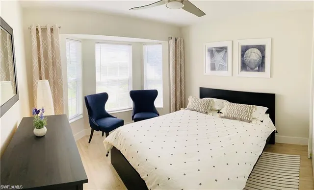 a bedroom with two beds and a window