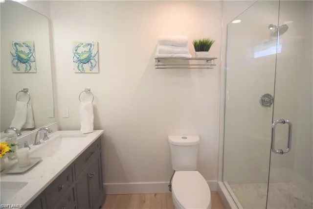 a bathroom with a sink vanity mirror and toilet