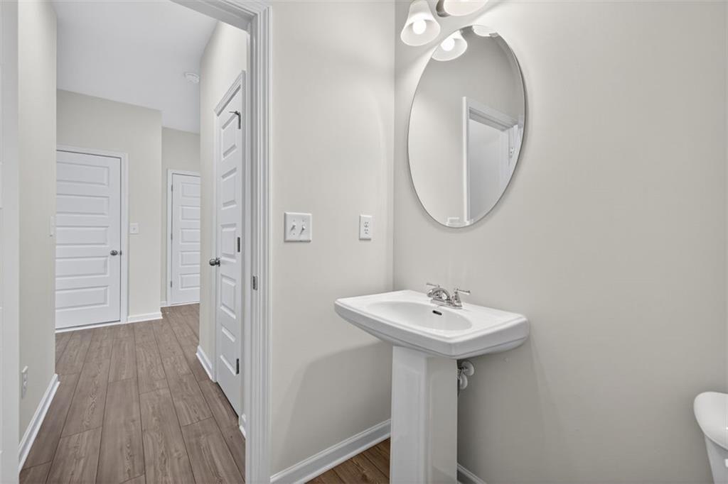 303 Roxeywood Way Winder, GA 30680 - Photo 16 of 47 a bathroom with a sink a mirror and a toilet