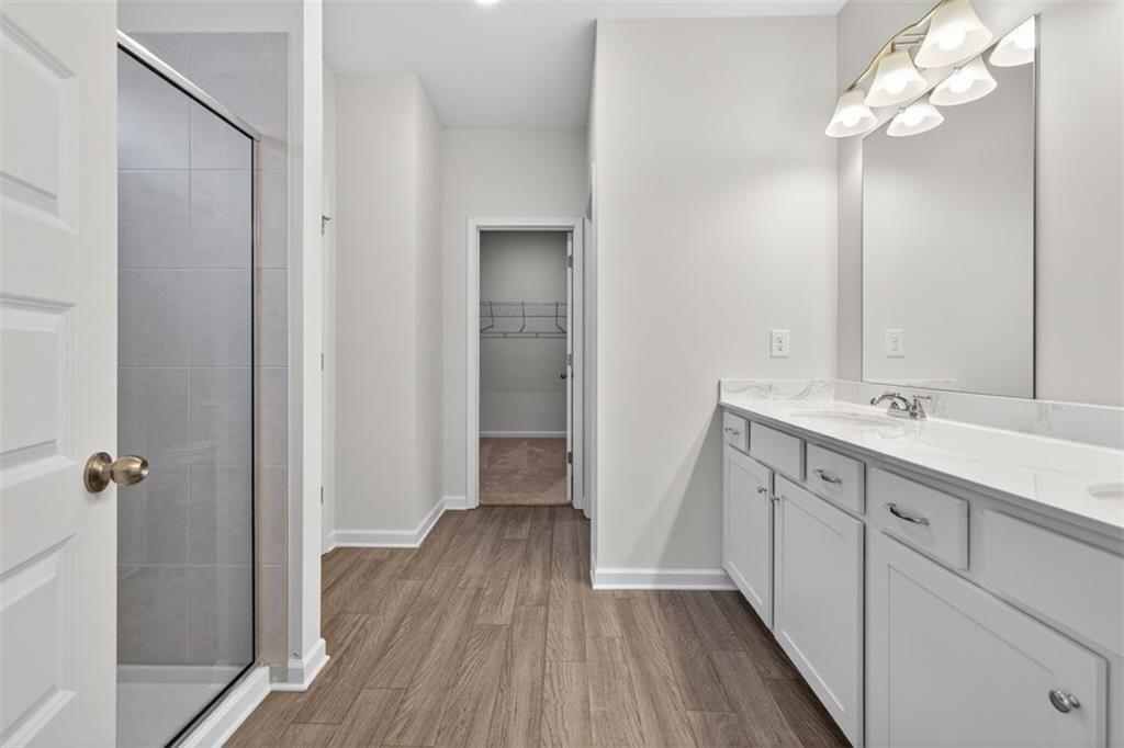 303 Roxeywood Way Winder, GA 30680 - Photo 31 of 47 a bathroom with a sink mirror and a shower